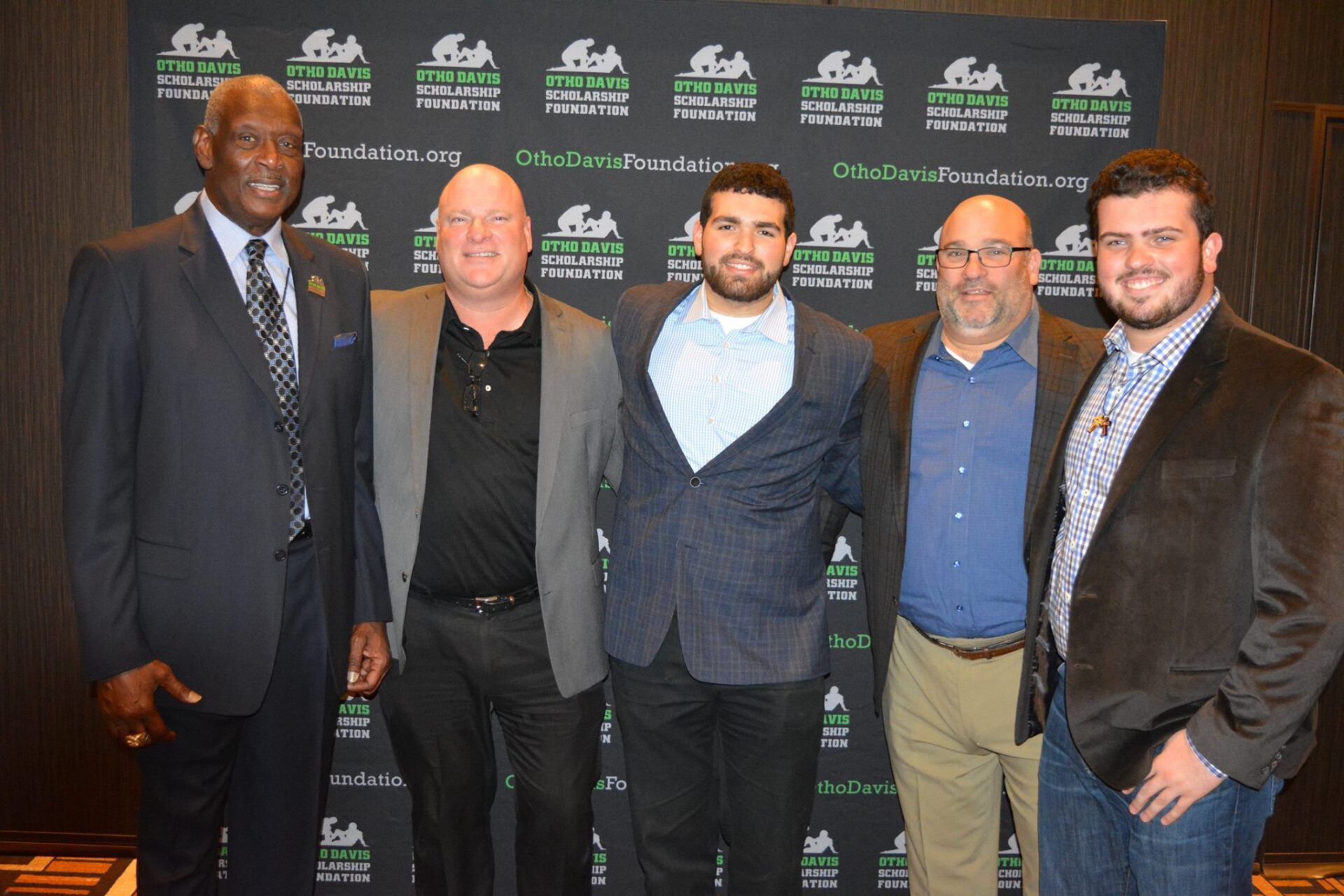A group of men in suits are posing for a picture.