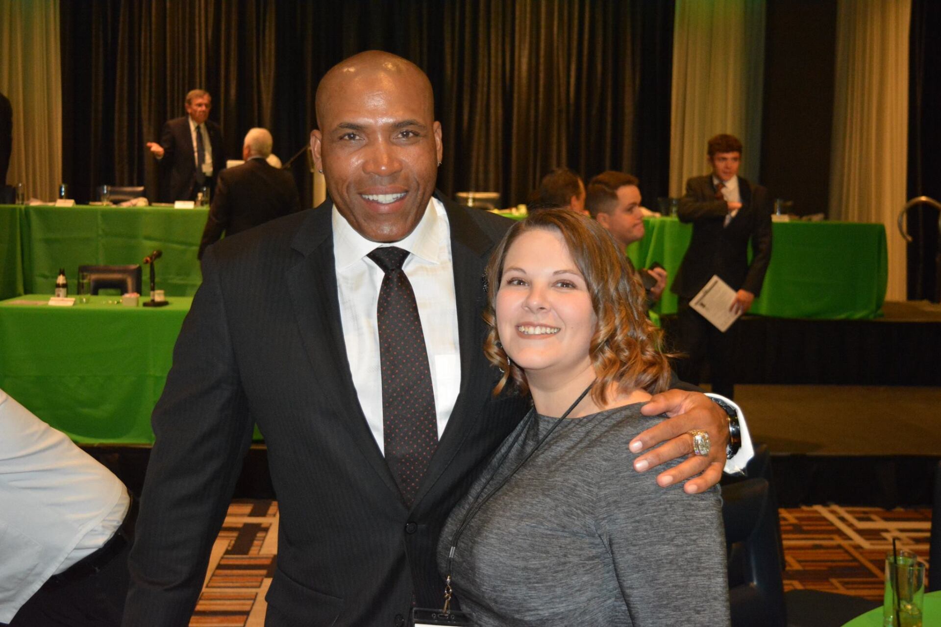A man in a suit and tie is posing for a picture with a woman.