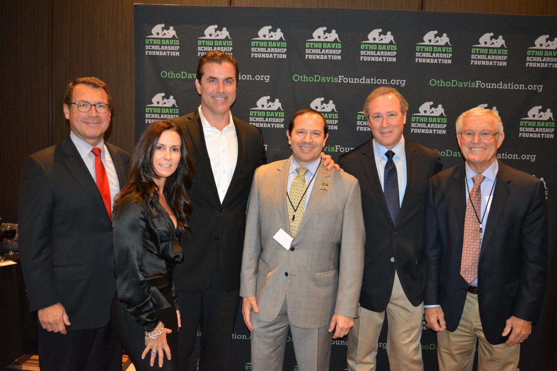 A group of people posing for a picture in front of a sign that says fish