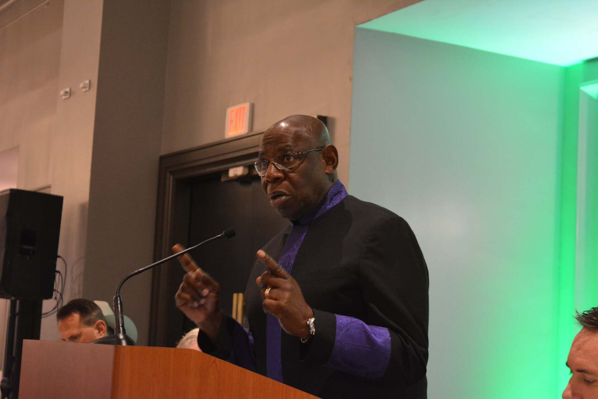 A man is standing at a podium giving a speech.