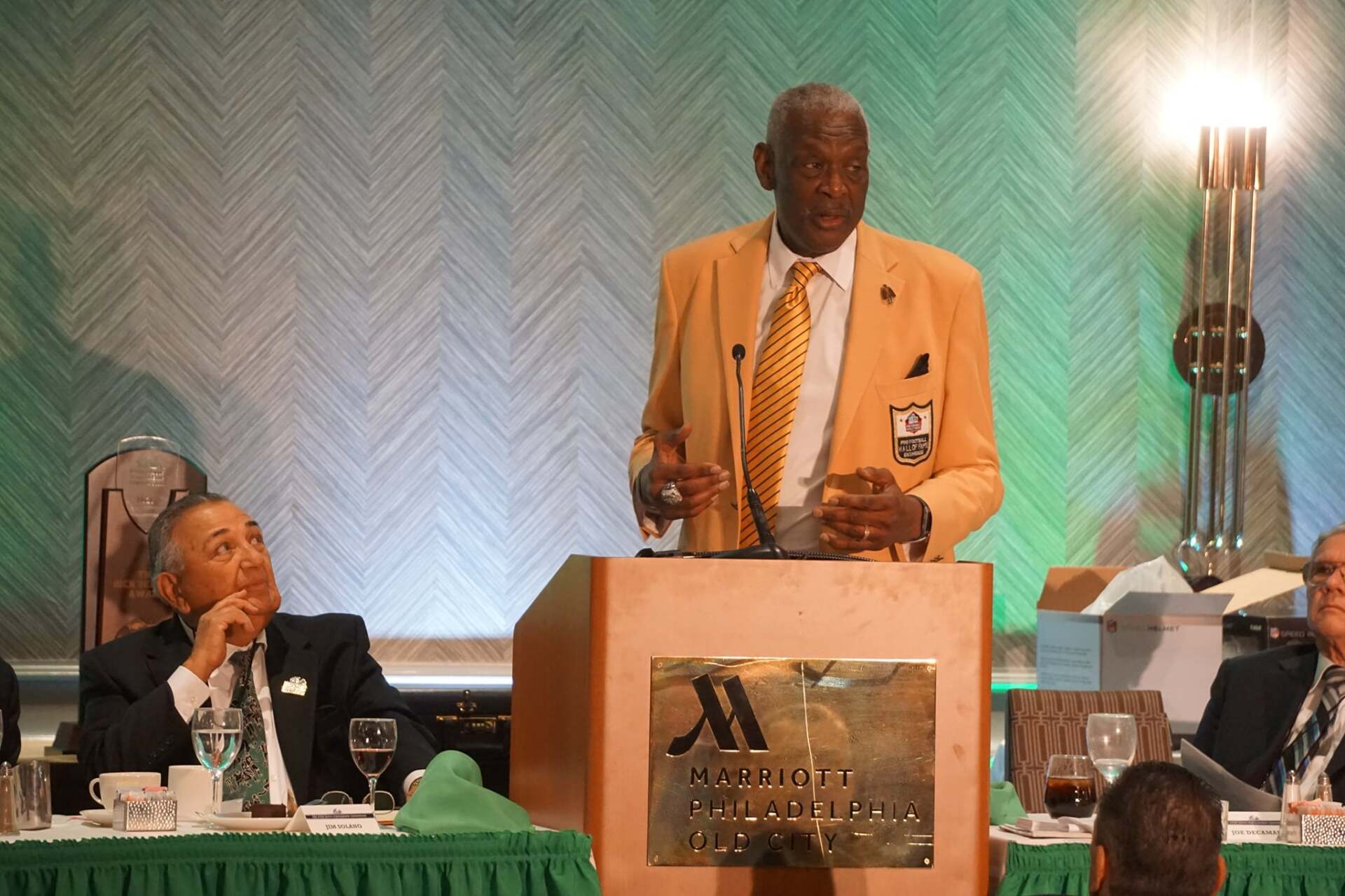 A man stands at a podium with a marriott logo on it