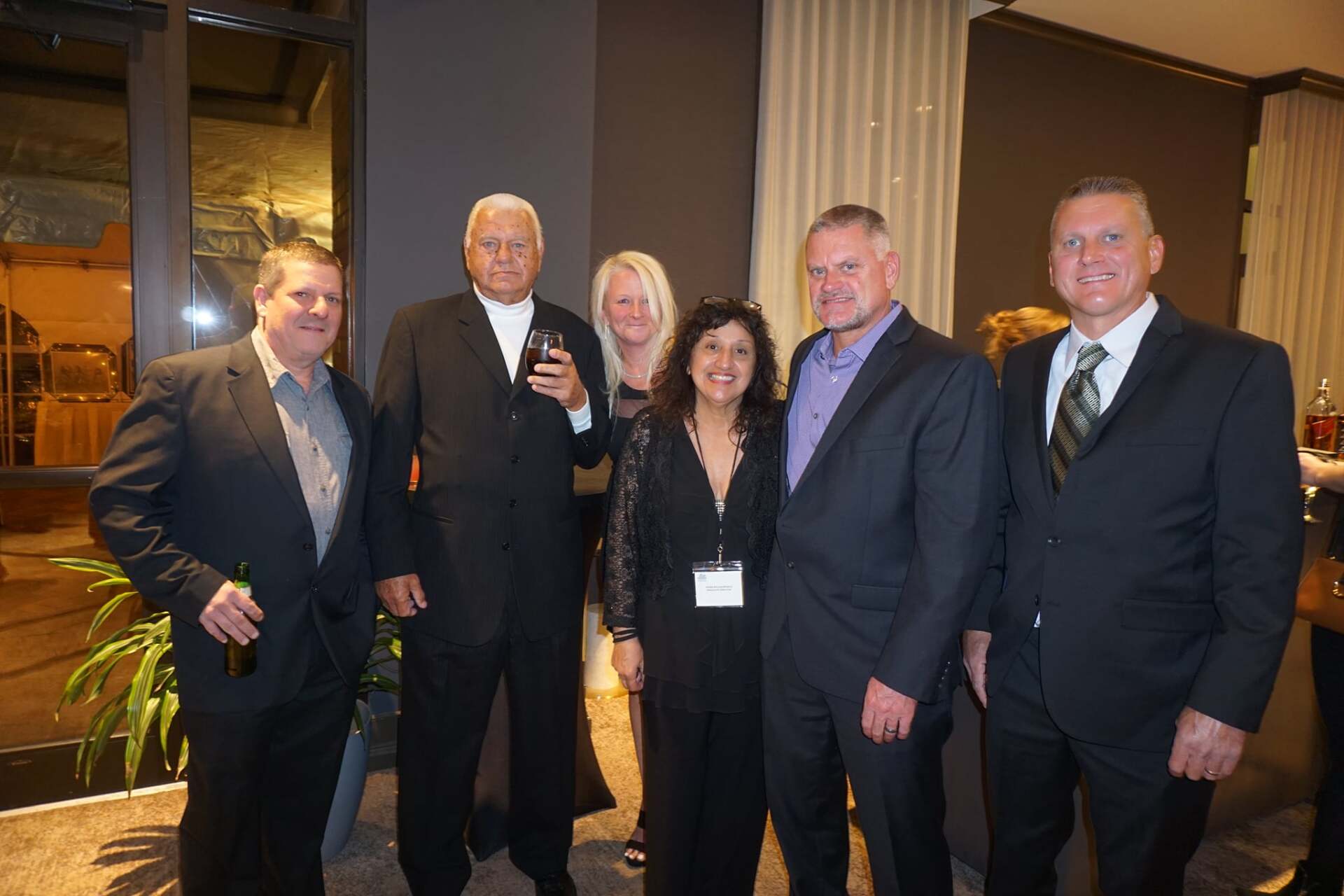 A group of people in suits and ties are posing for a picture.