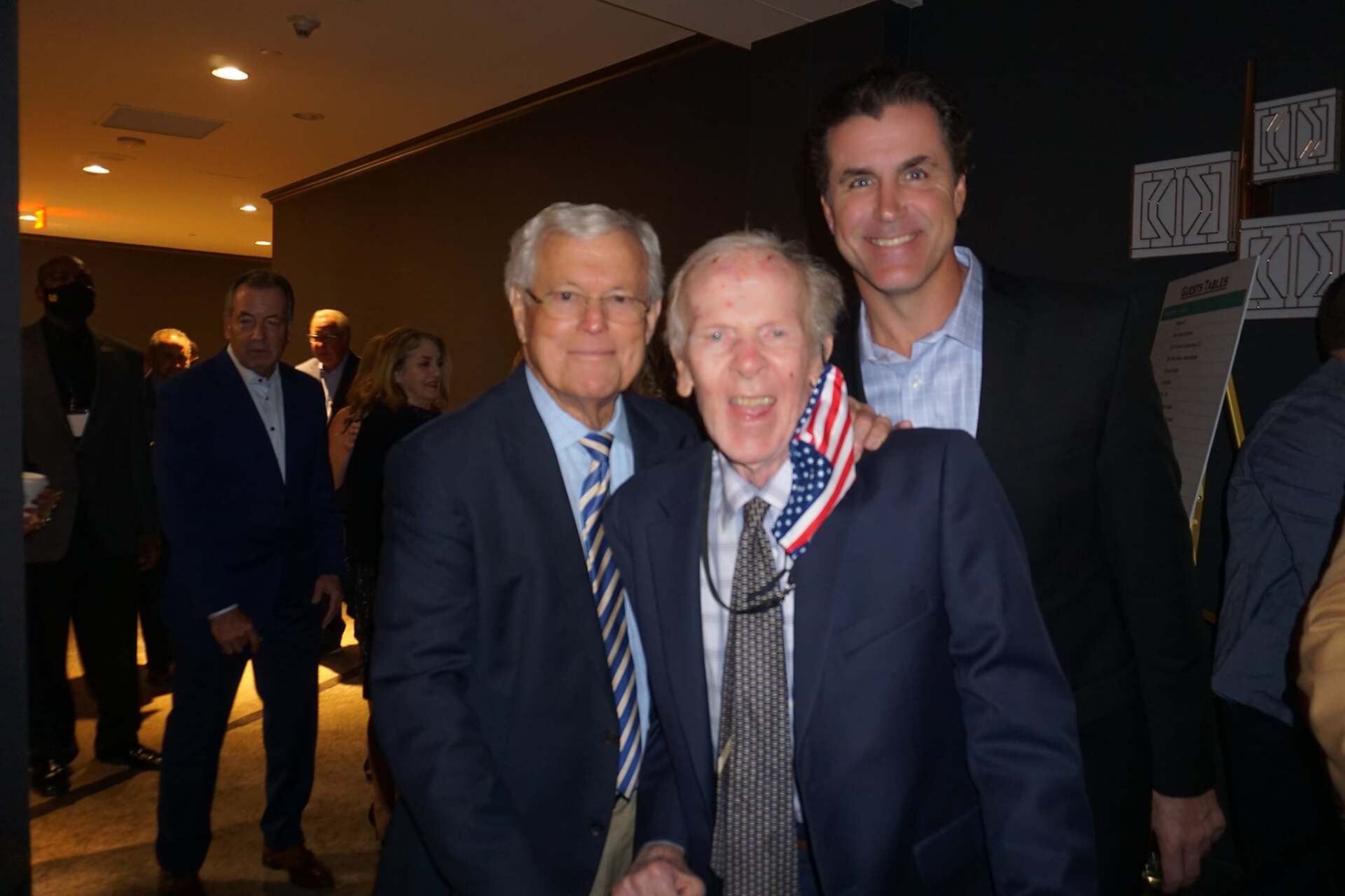 Two men in suits and ties are posing for a picture