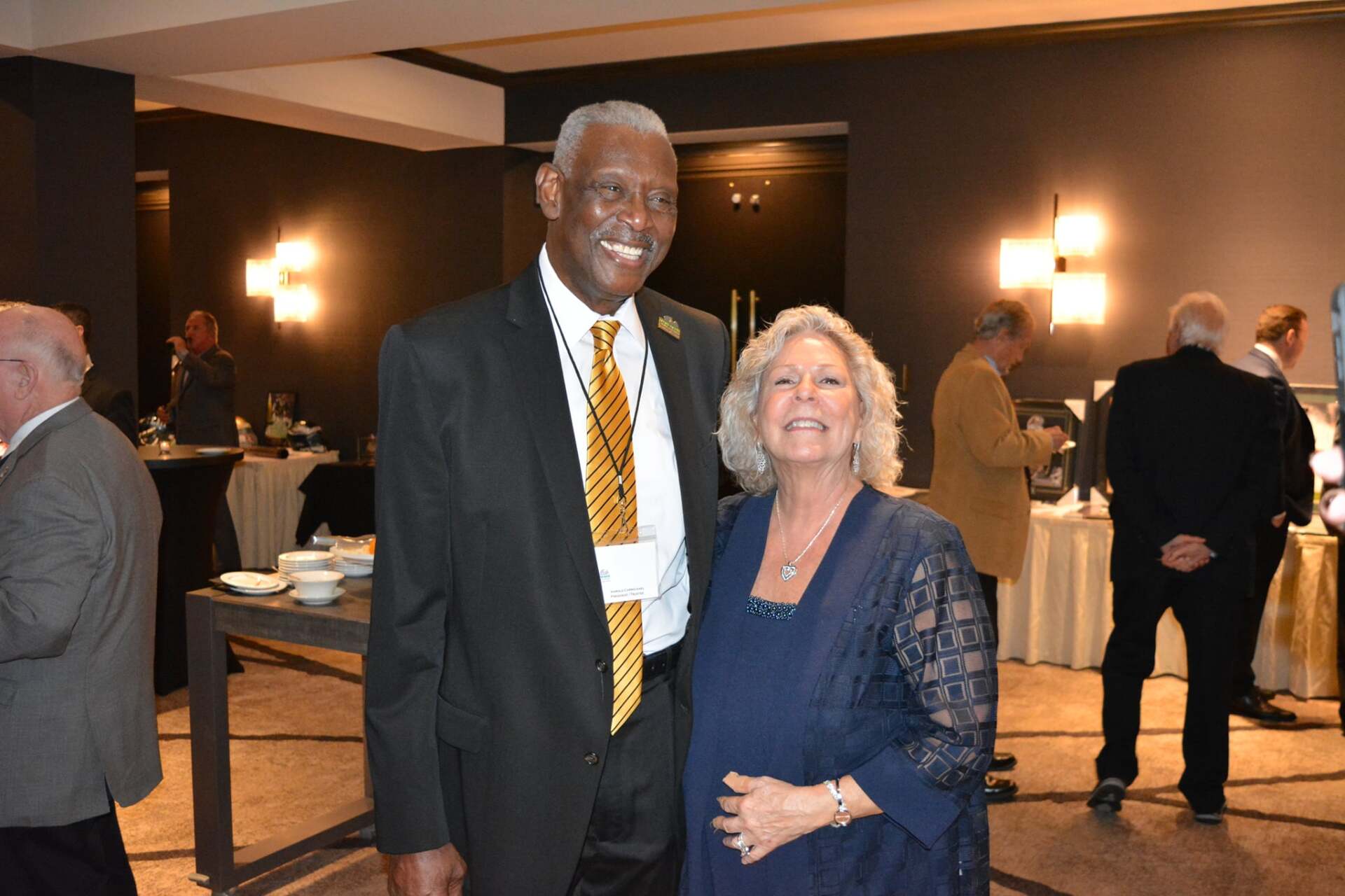 A man and a woman are posing for a picture in a room.
