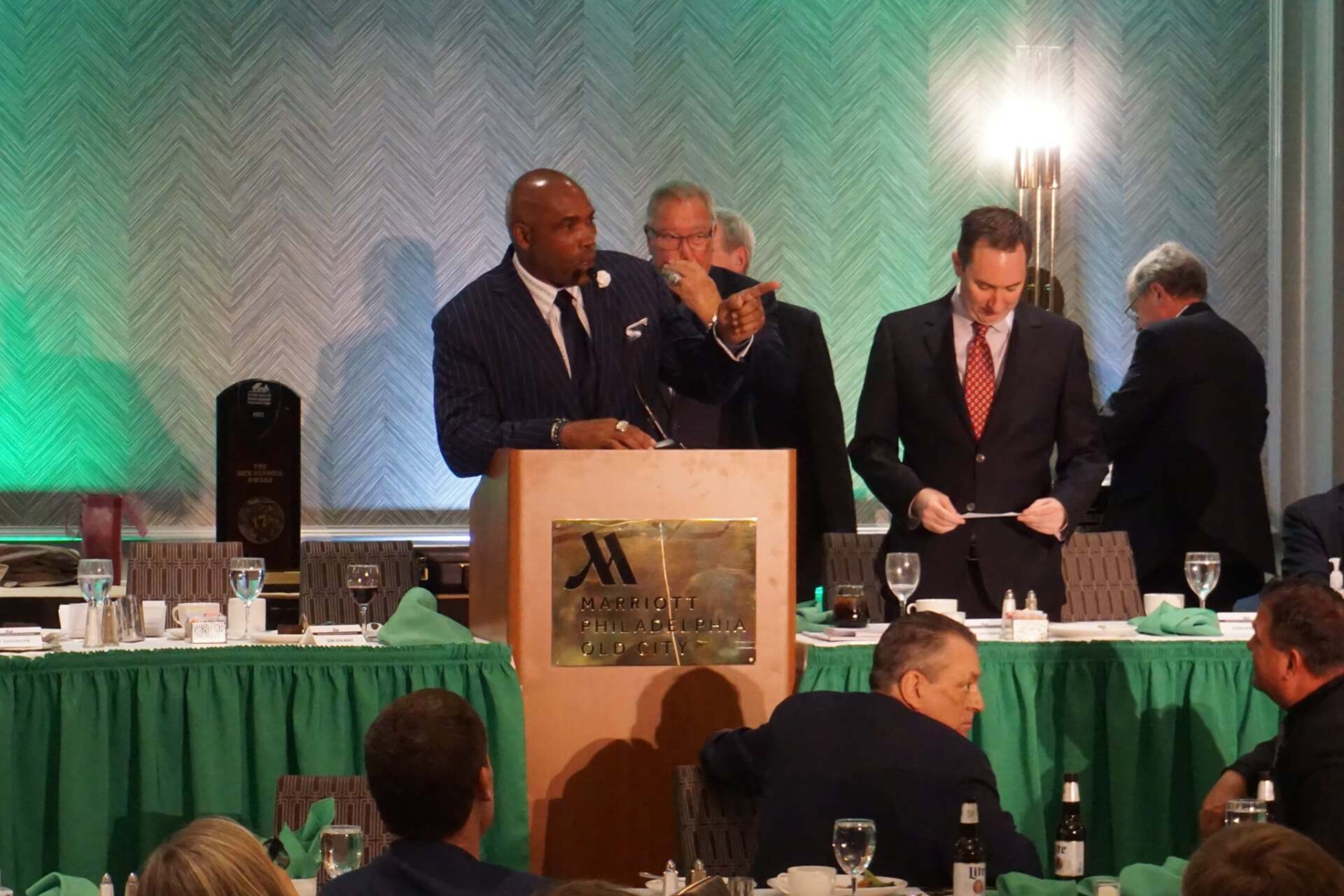 A man stands at a podium that says marriott on it