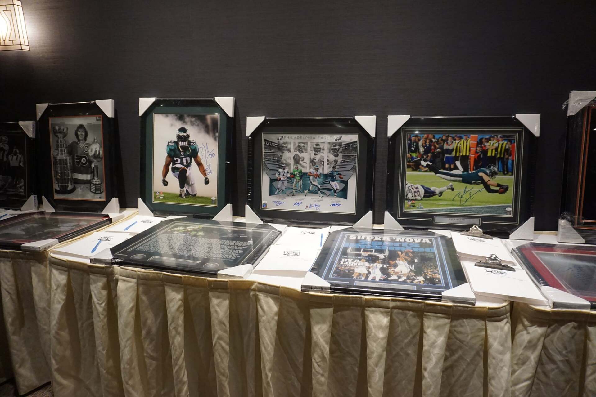 A table with a bunch of framed pictures on it