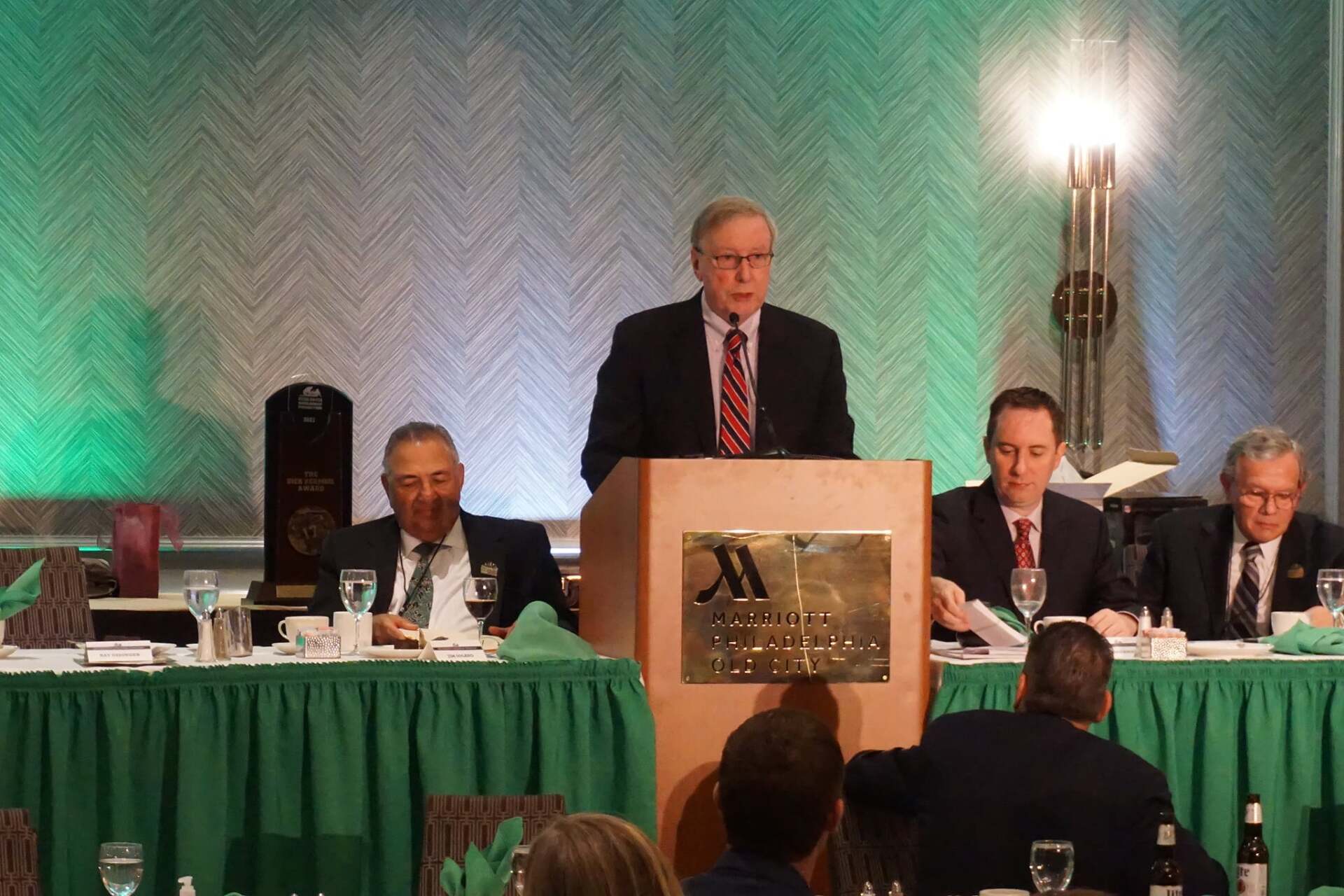 A man stands at a podium with a marriott logo on it