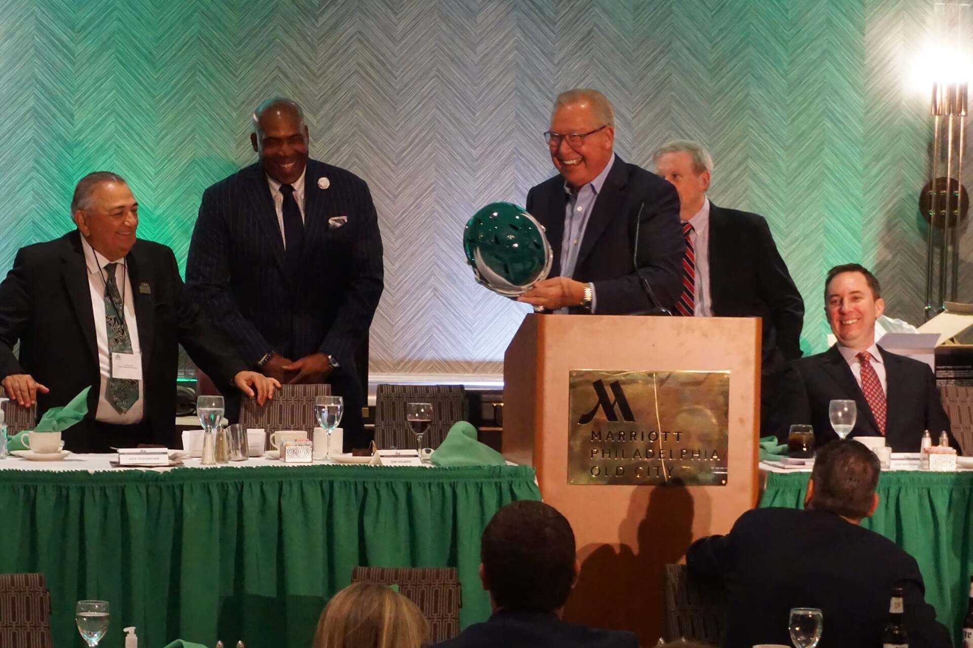 A man stands at a podium with a marriott logo on it