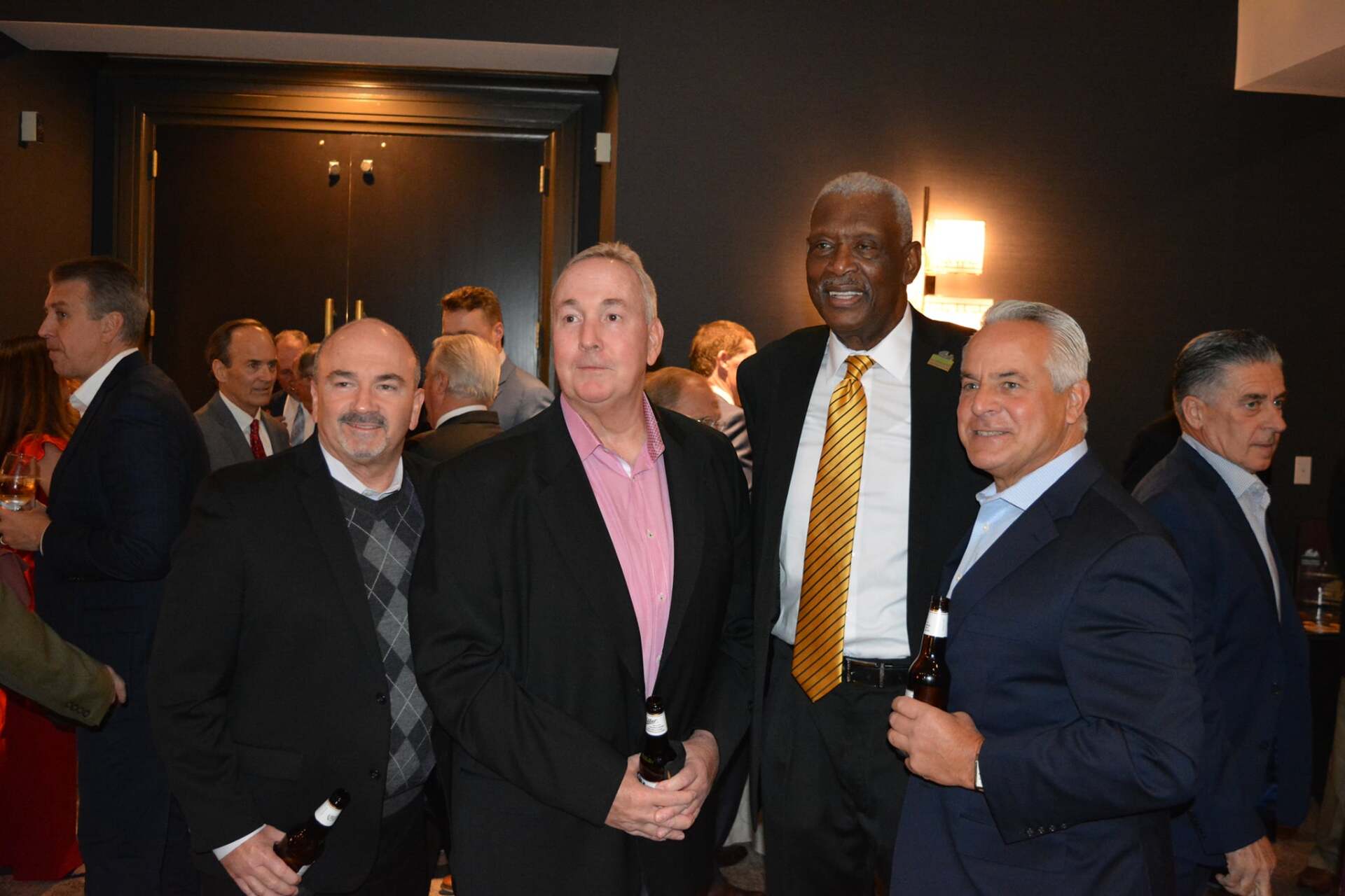 A group of men in suits and ties are posing for a picture.