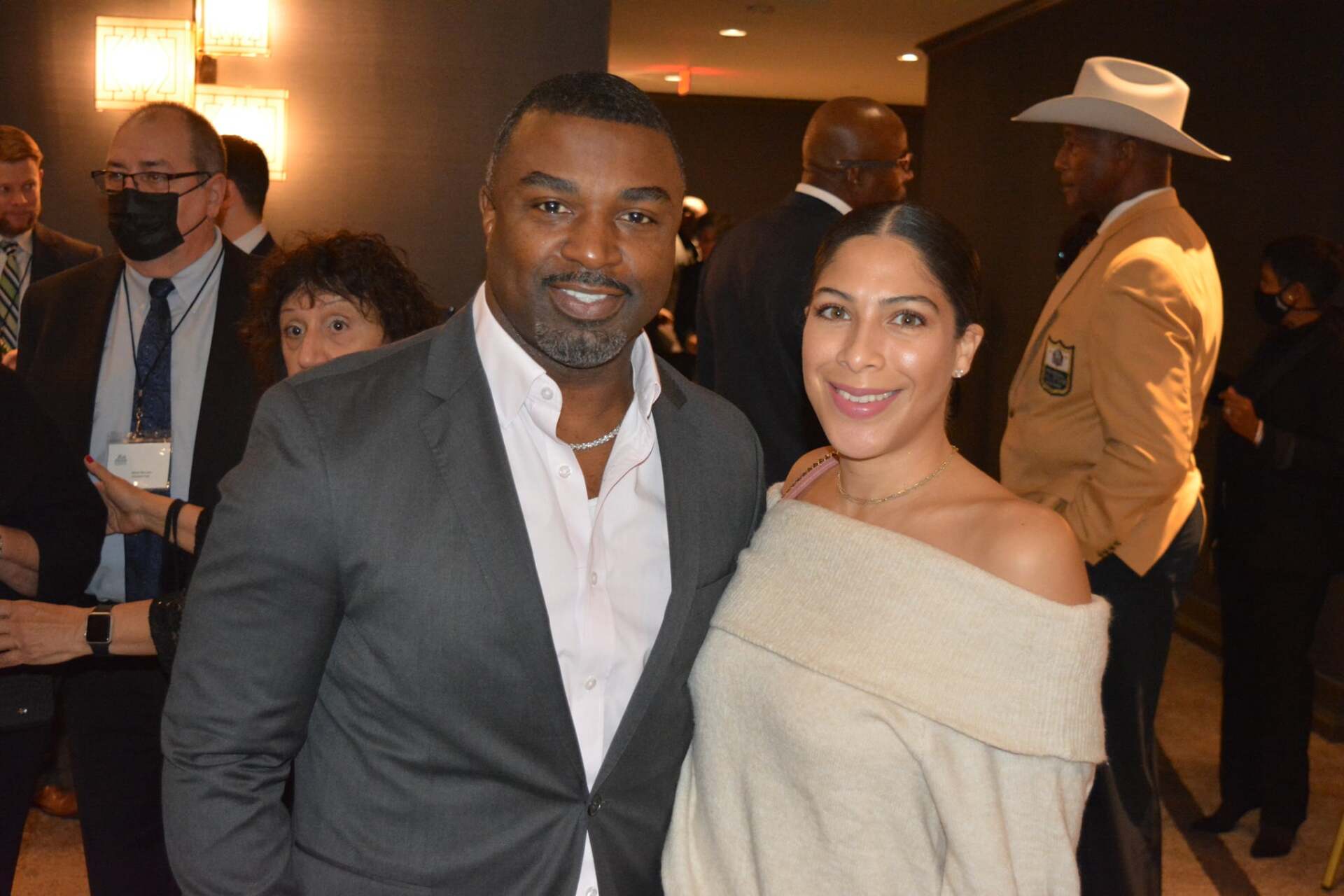 A man and a woman are posing for a picture at a party.