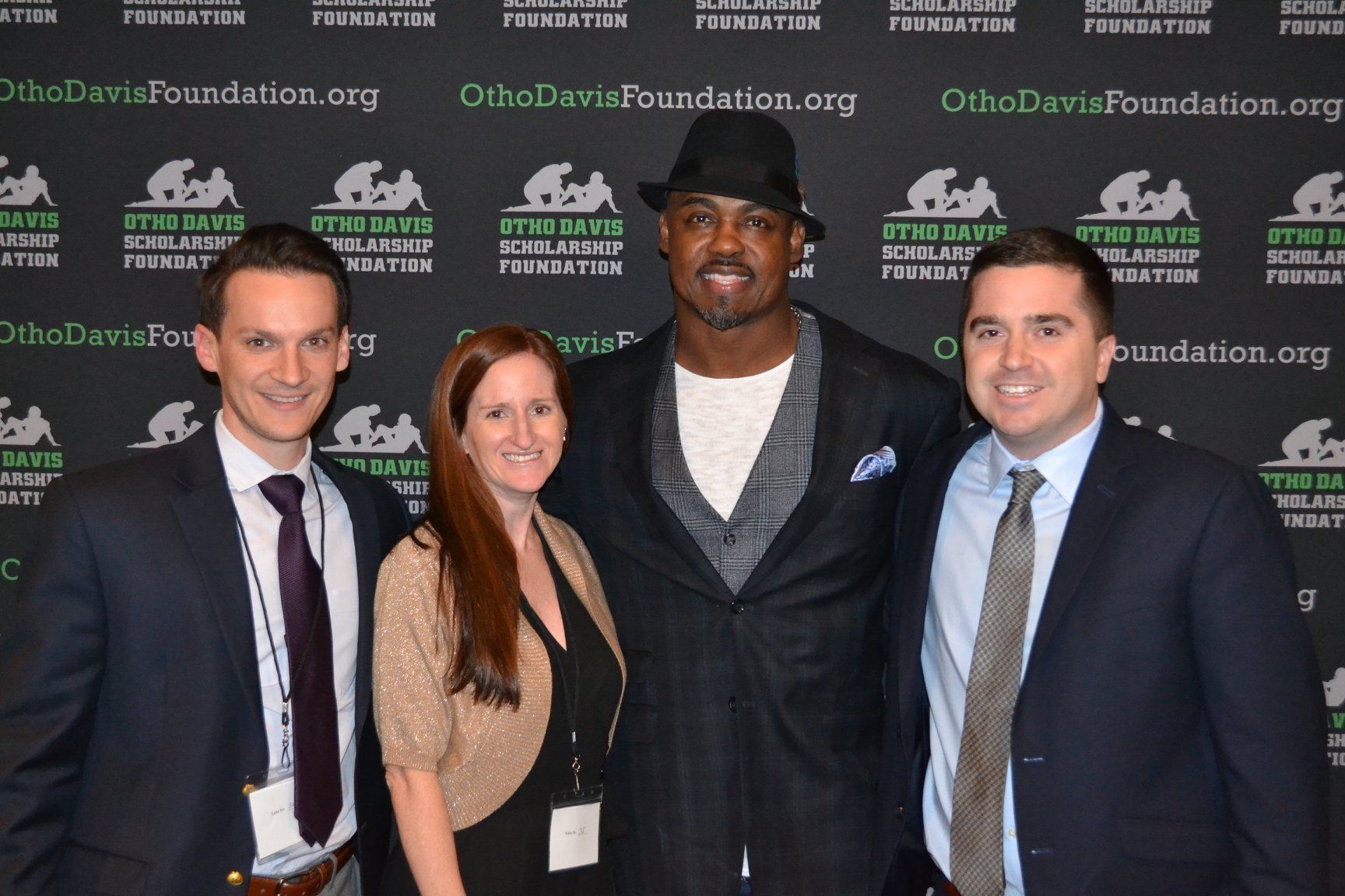 A group of people posing for a picture in front of a wall that says ohiodavisfoundation.org