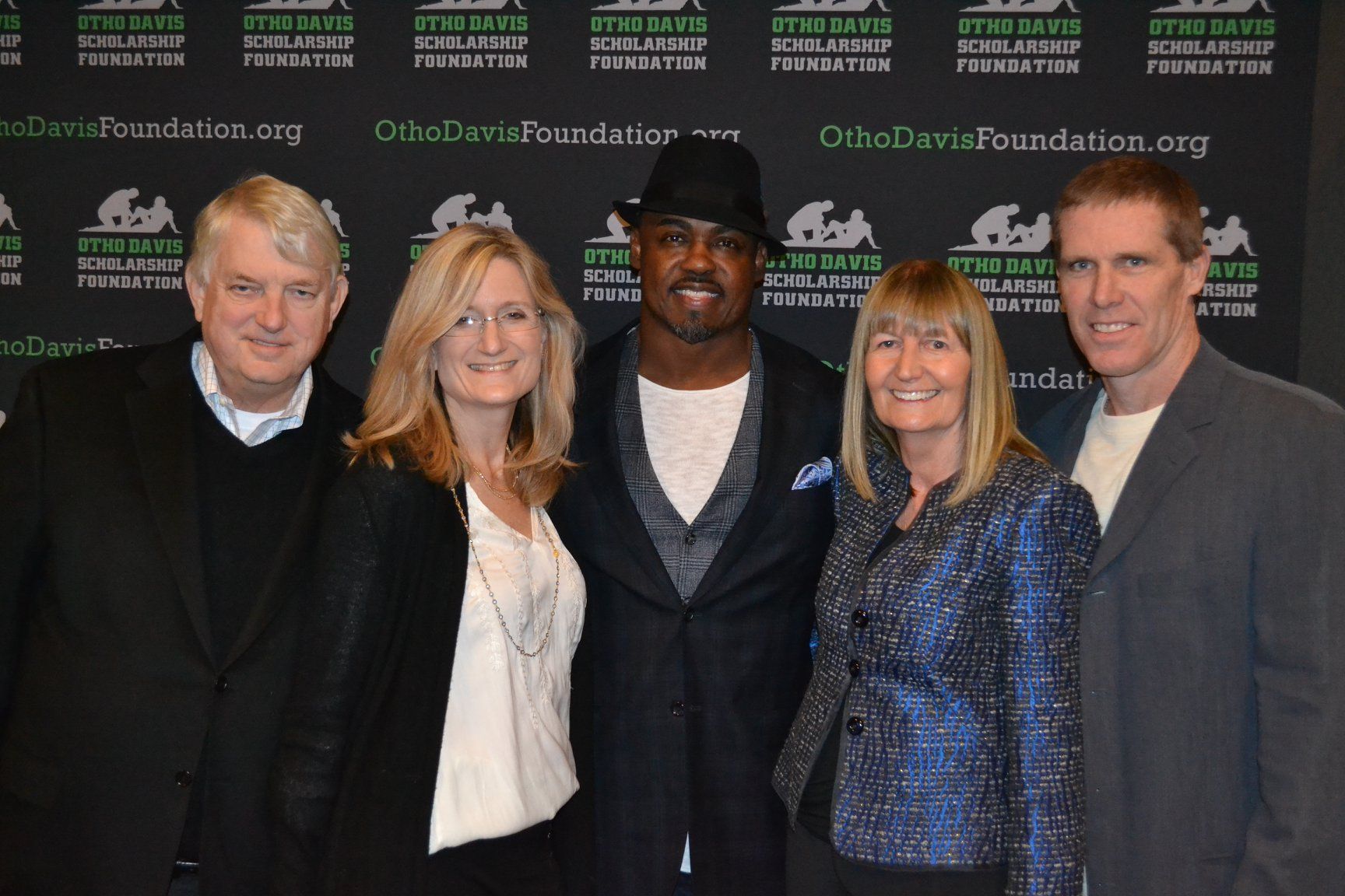A group of people posing for a picture in front of a wall that says ohio dutch foundation