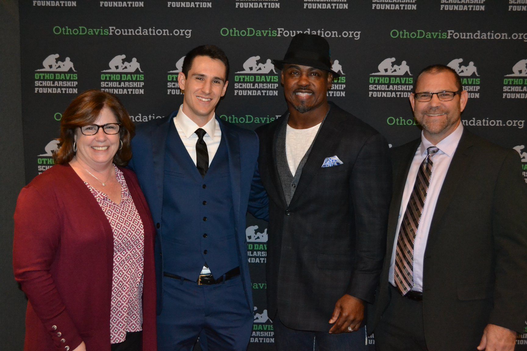 A group of people are posing for a picture in front of a wall that says ottawa foundation