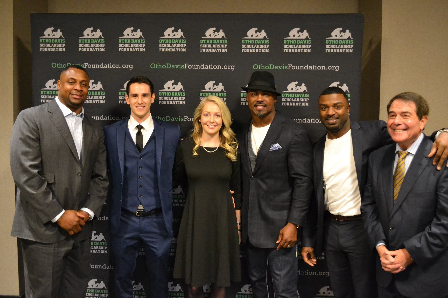 A group of people posing for a picture in front of a sign that says fish