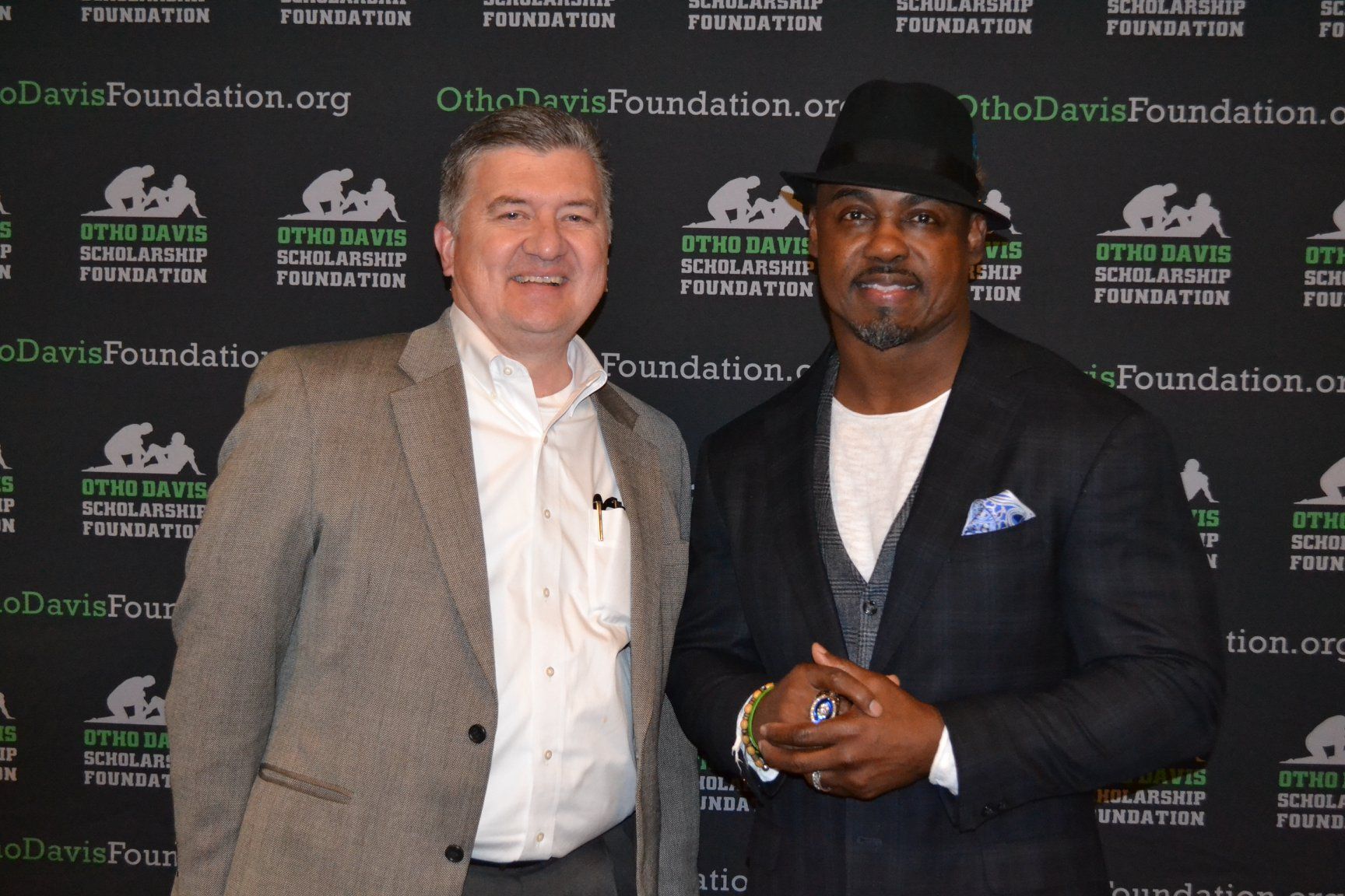 Two men standing in front of a wall that says the davis foundation