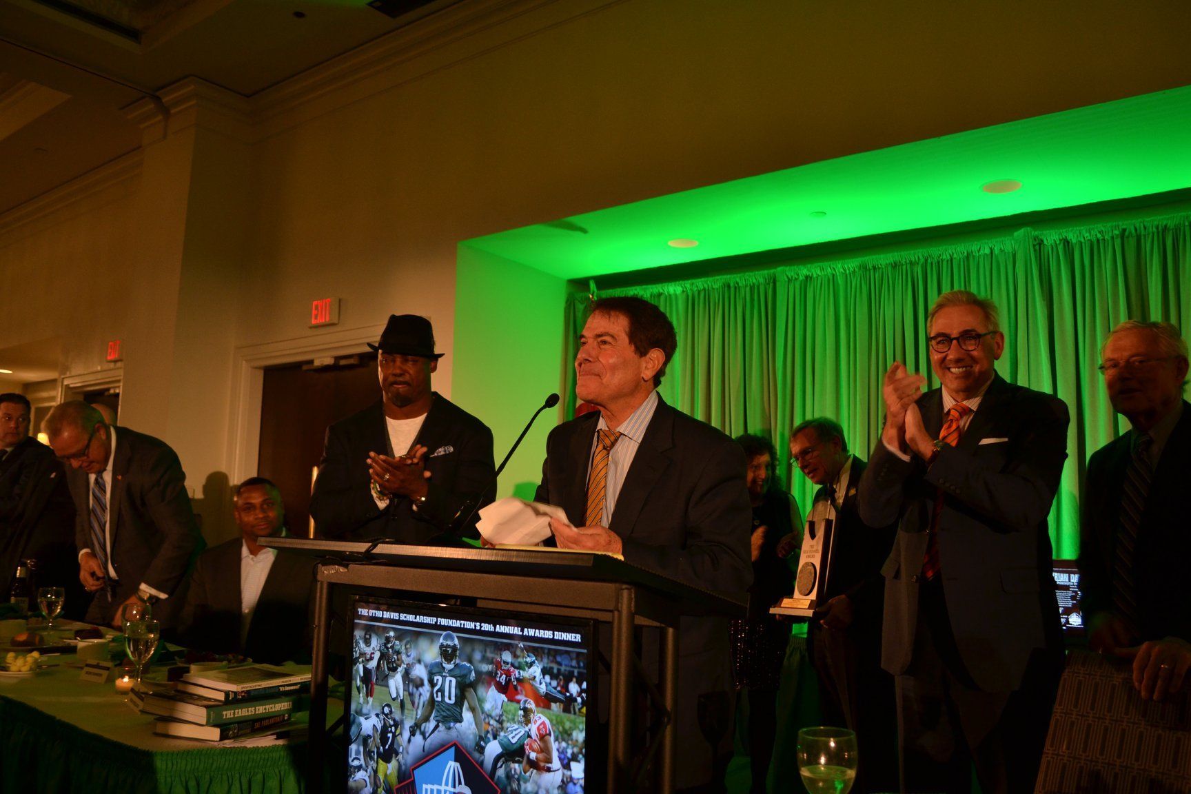 A man in a suit and tie is standing at a podium giving a speech.