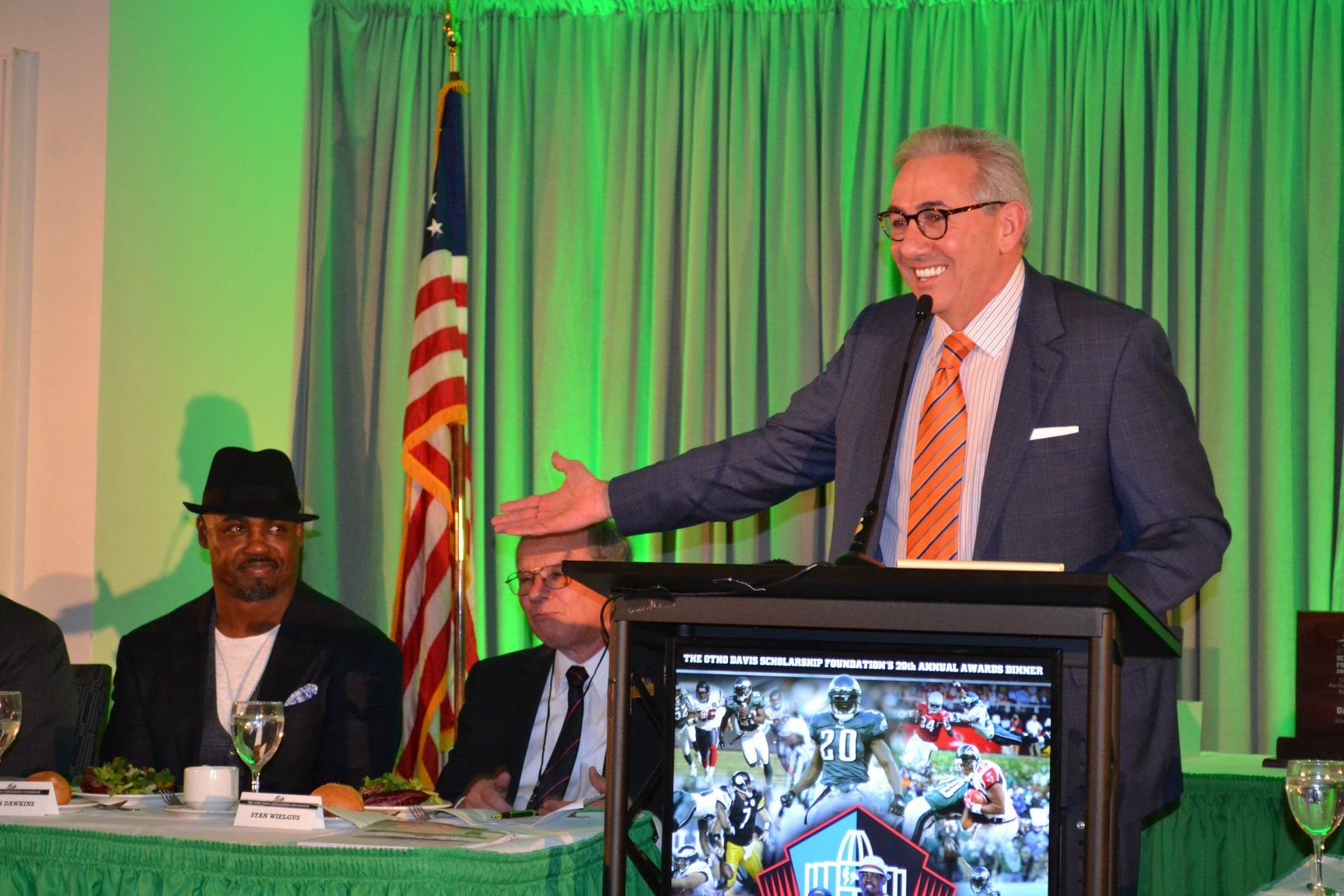 A man in a suit and tie is standing at a podium giving a speech.