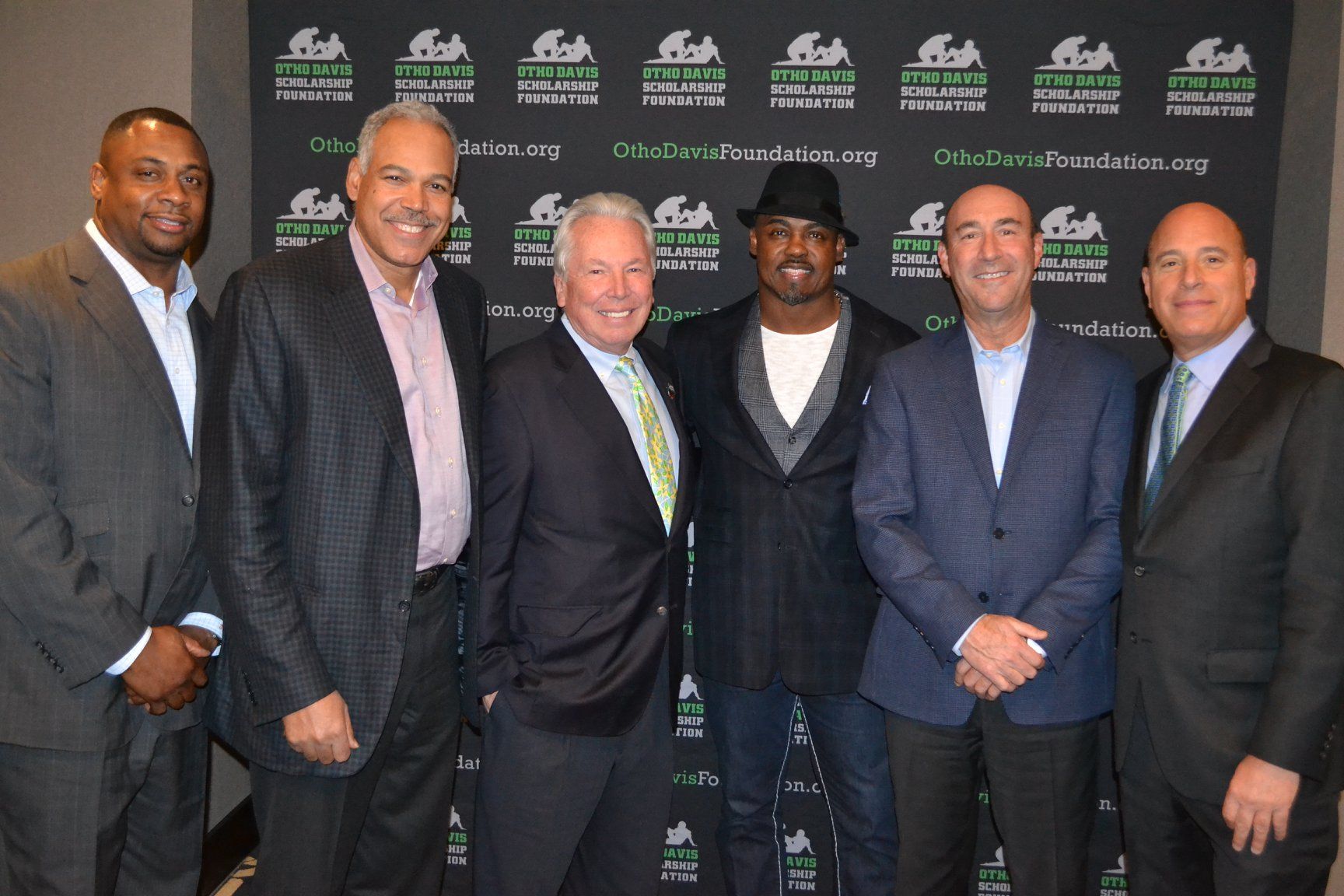 A group of men in suits are posing for a picture