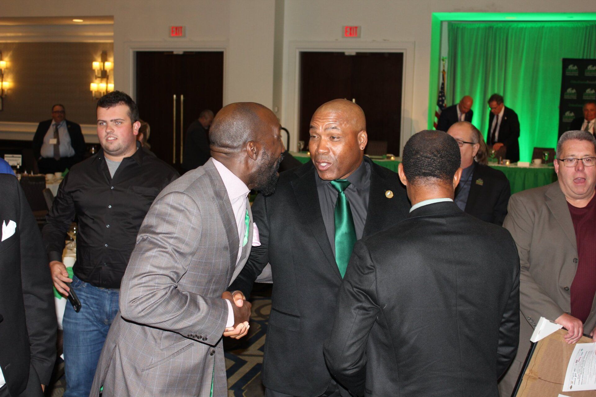 A group of men are shaking hands in a room