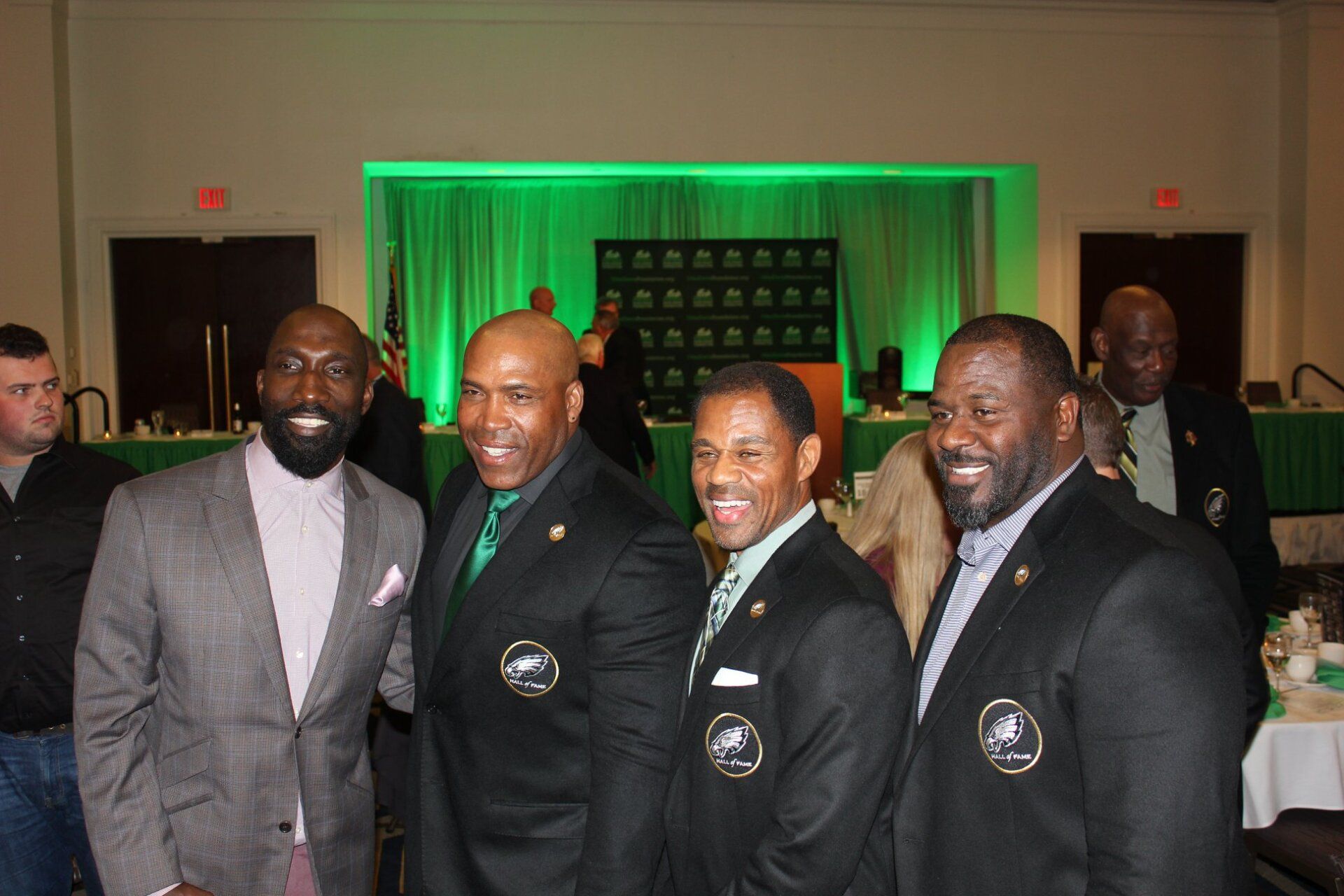 A group of men in suits are posing for a picture