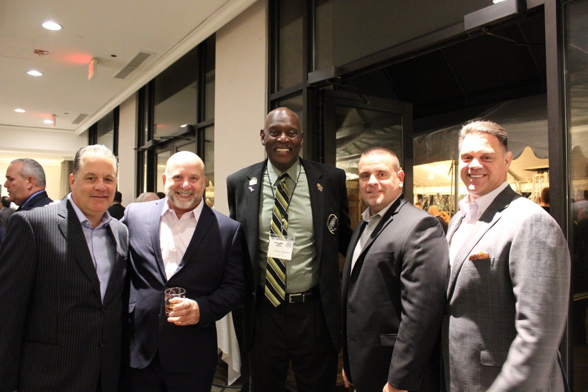 A group of men in suits and ties are posing for a picture.