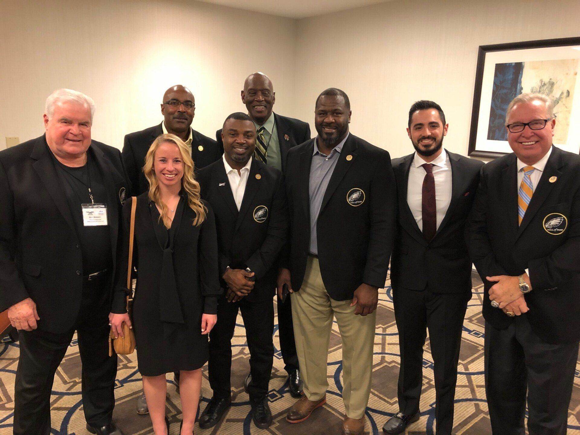 A group of people are posing for a picture in a room.