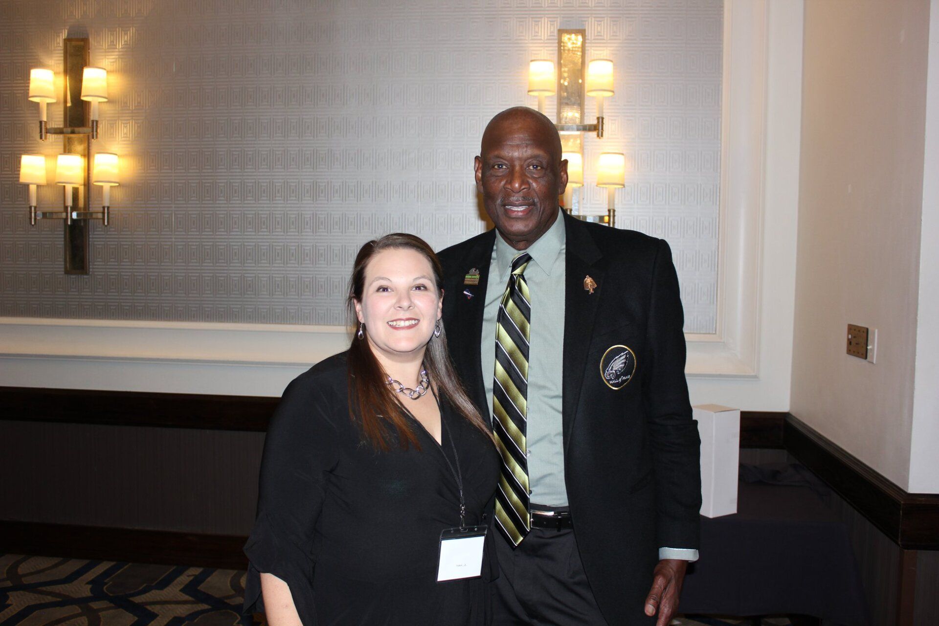 A man and a woman are posing for a picture in a room.
