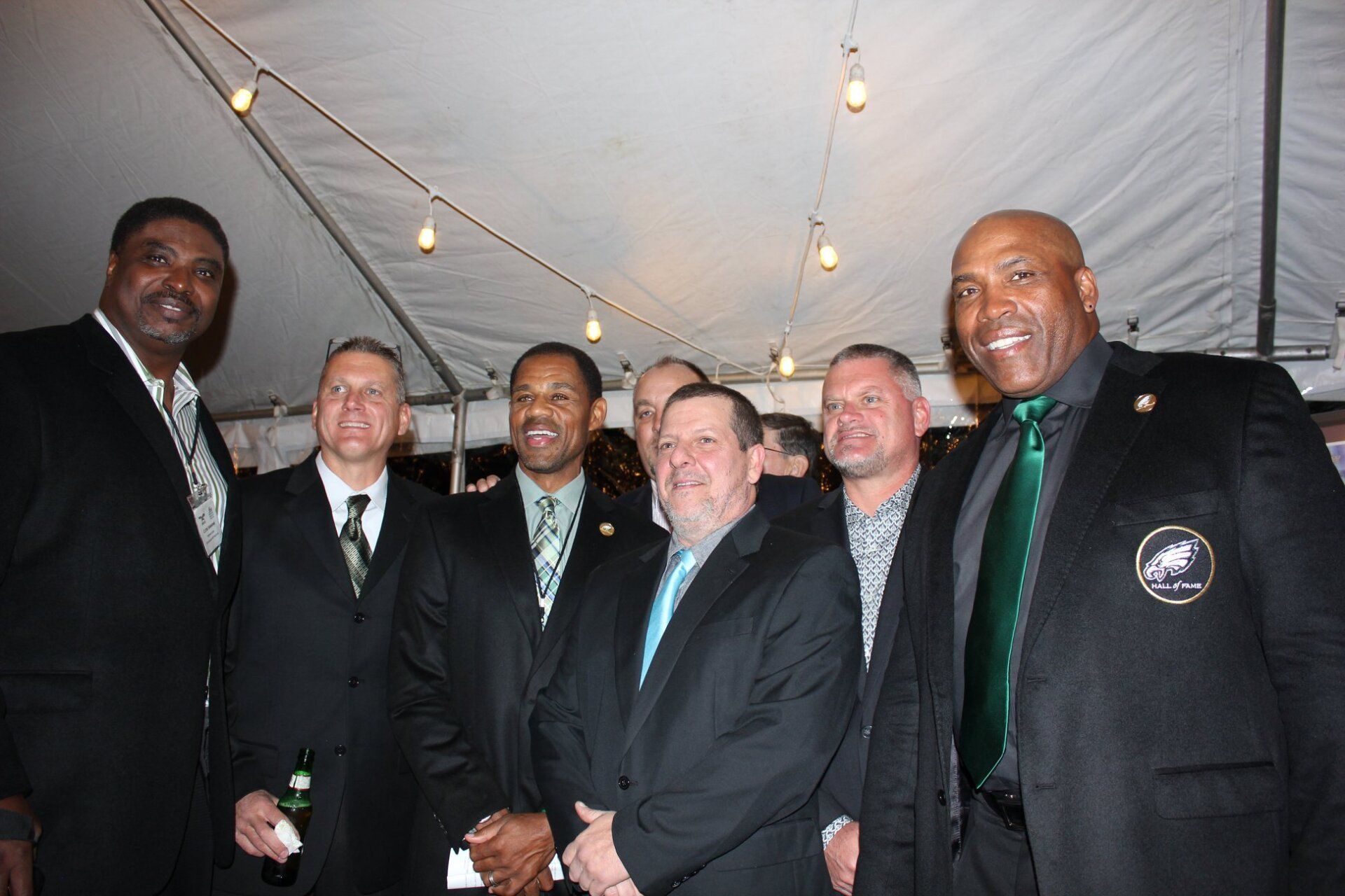 A group of men in suits are posing for a picture