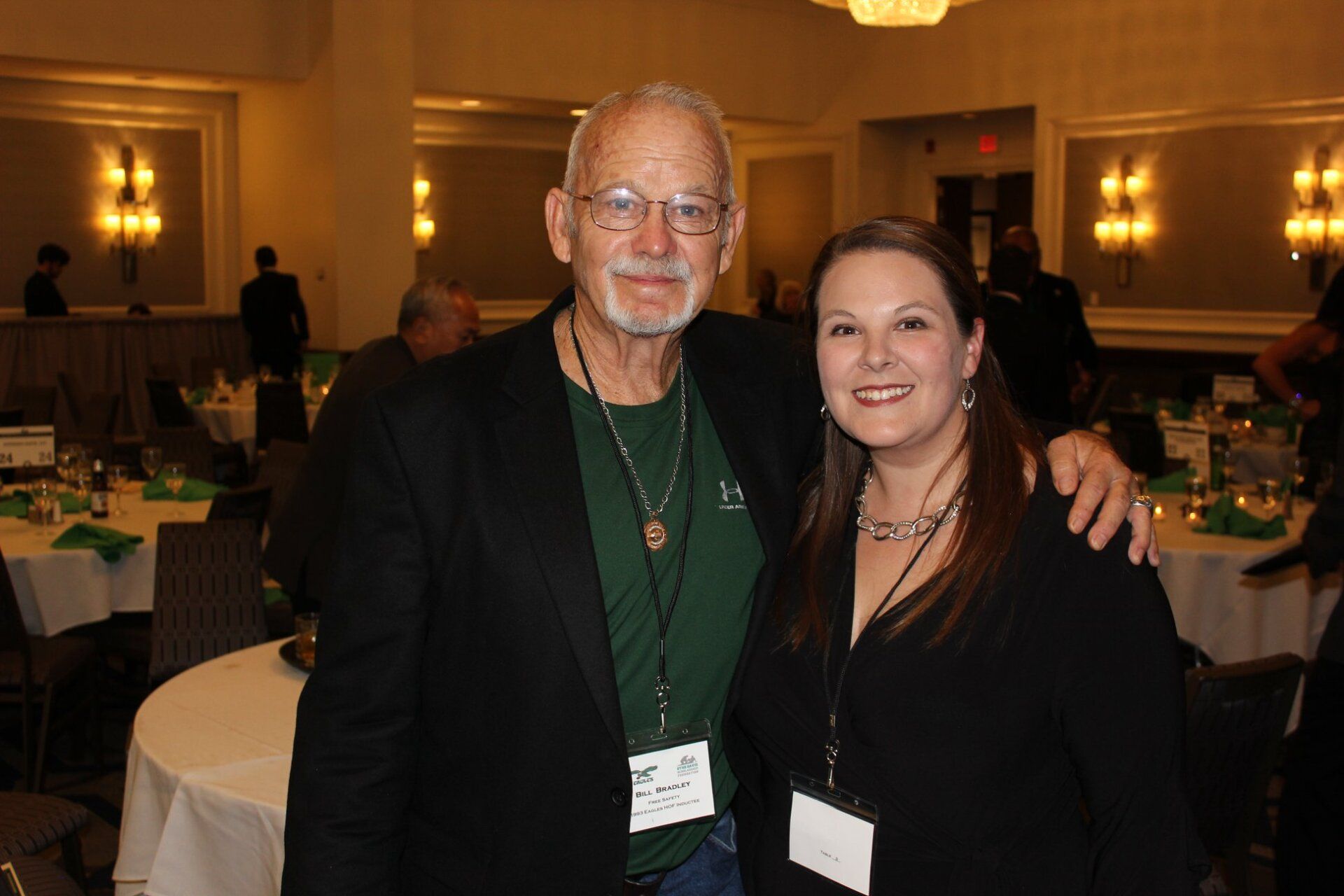 A man and a woman are posing for a picture in a room.