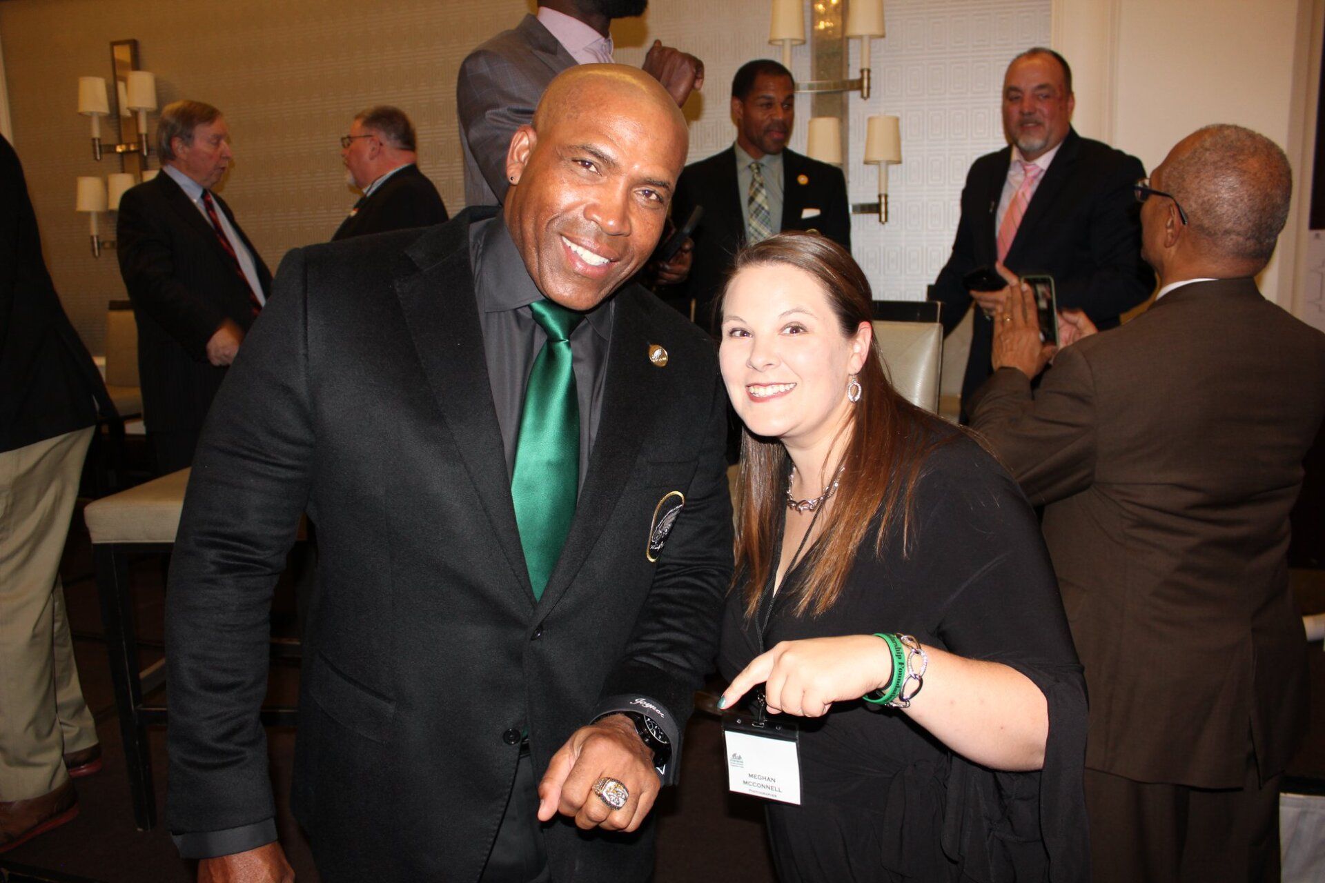 A man in a suit and tie is posing for a picture with a woman