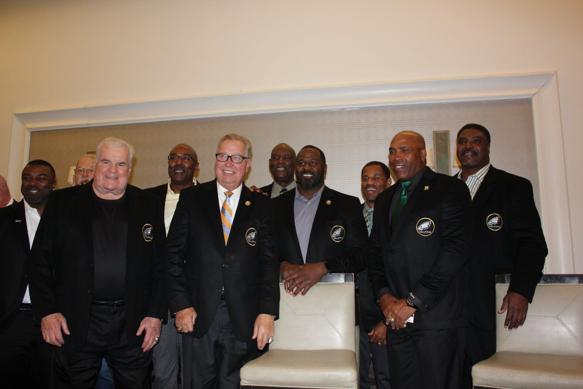 A group of men in suits are posing for a picture.