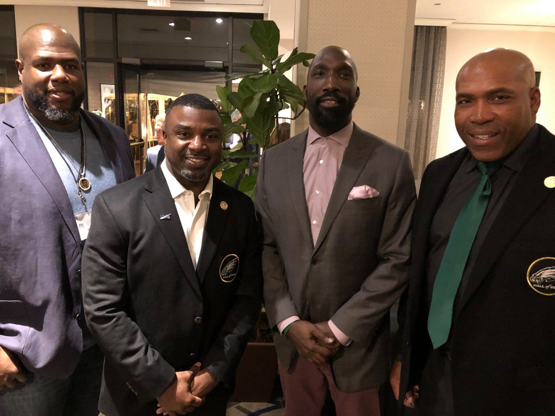 A group of men in suits and ties are posing for a picture.
