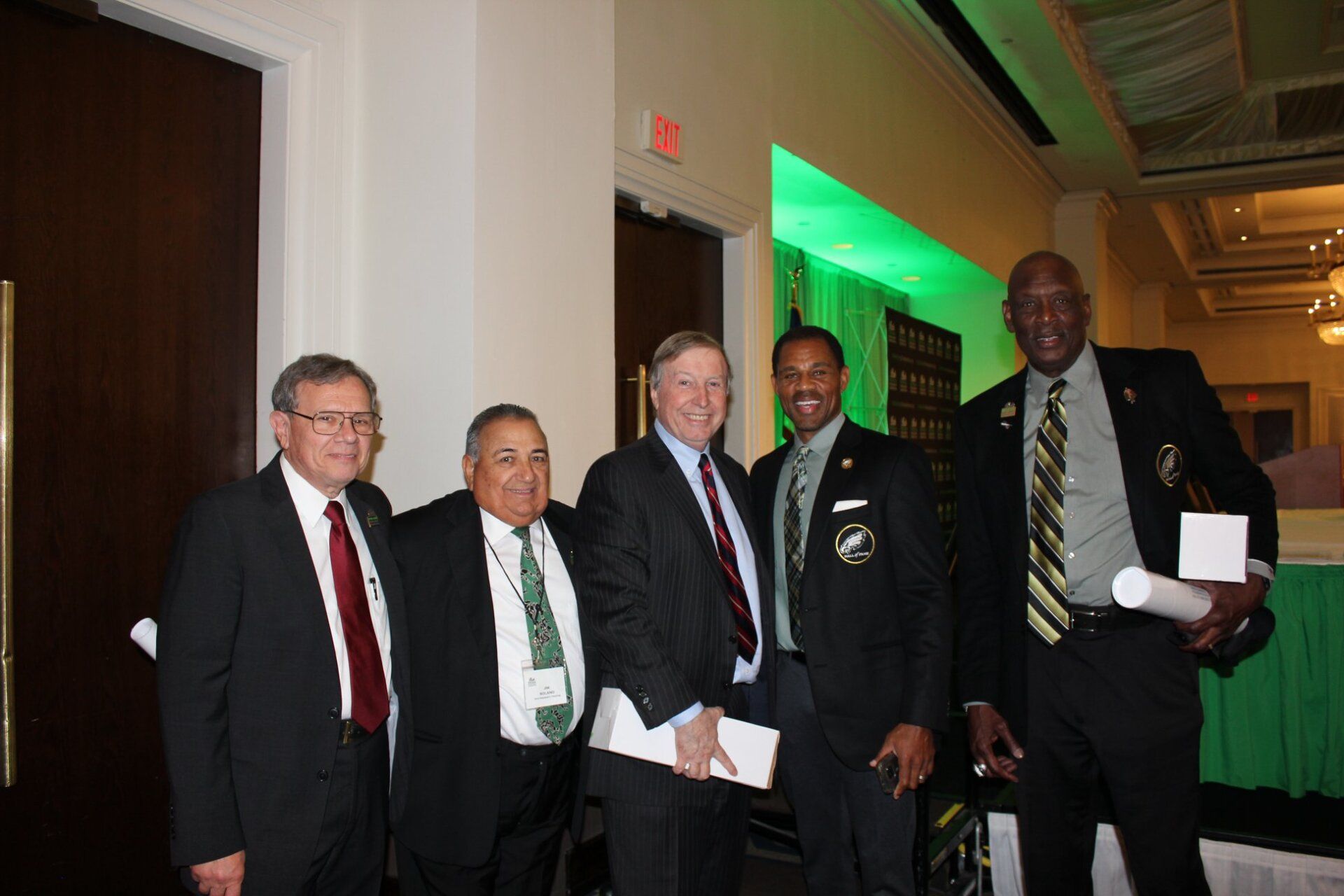 A group of men in suits and ties pose for a picture