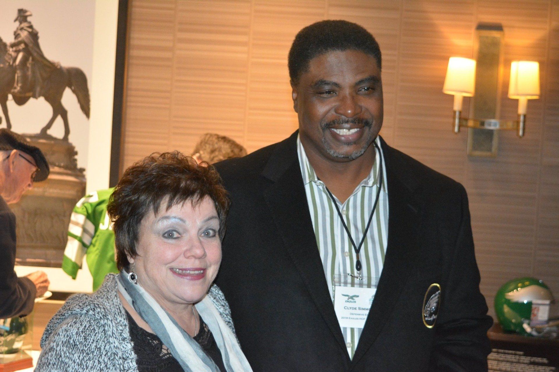 A man and a woman are posing for a picture in a room.