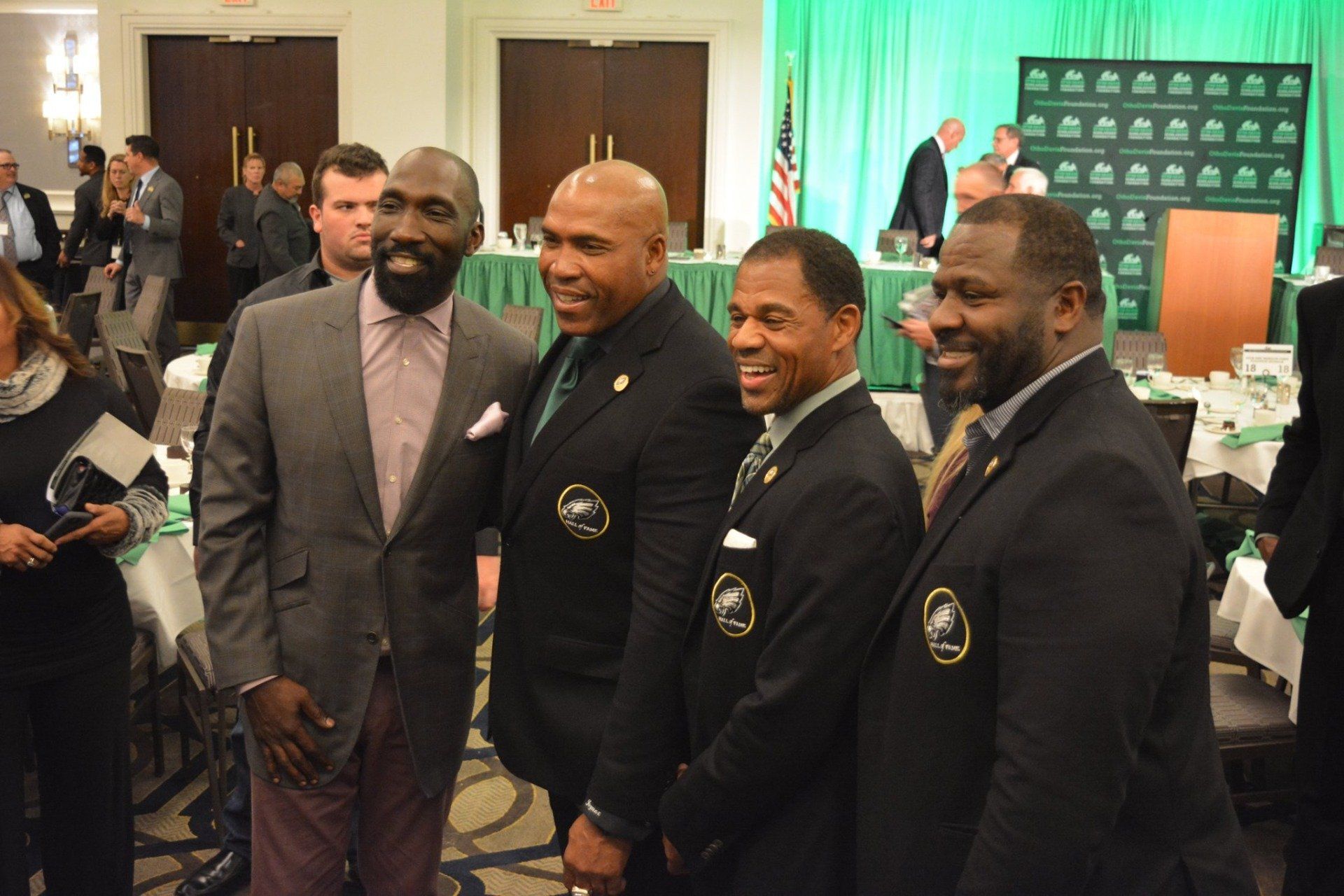 A group of men in suits are posing for a picture in a room.