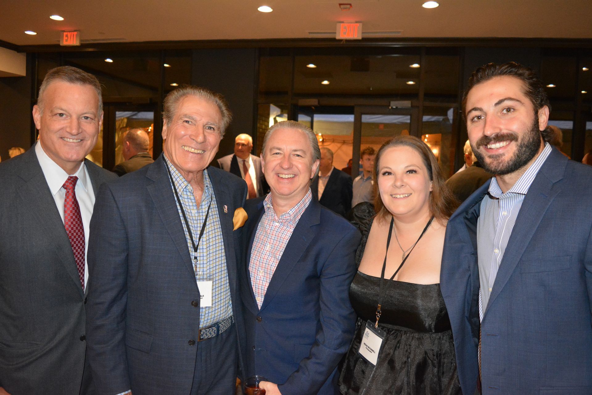 A group of people in suits and ties are posing for a picture.