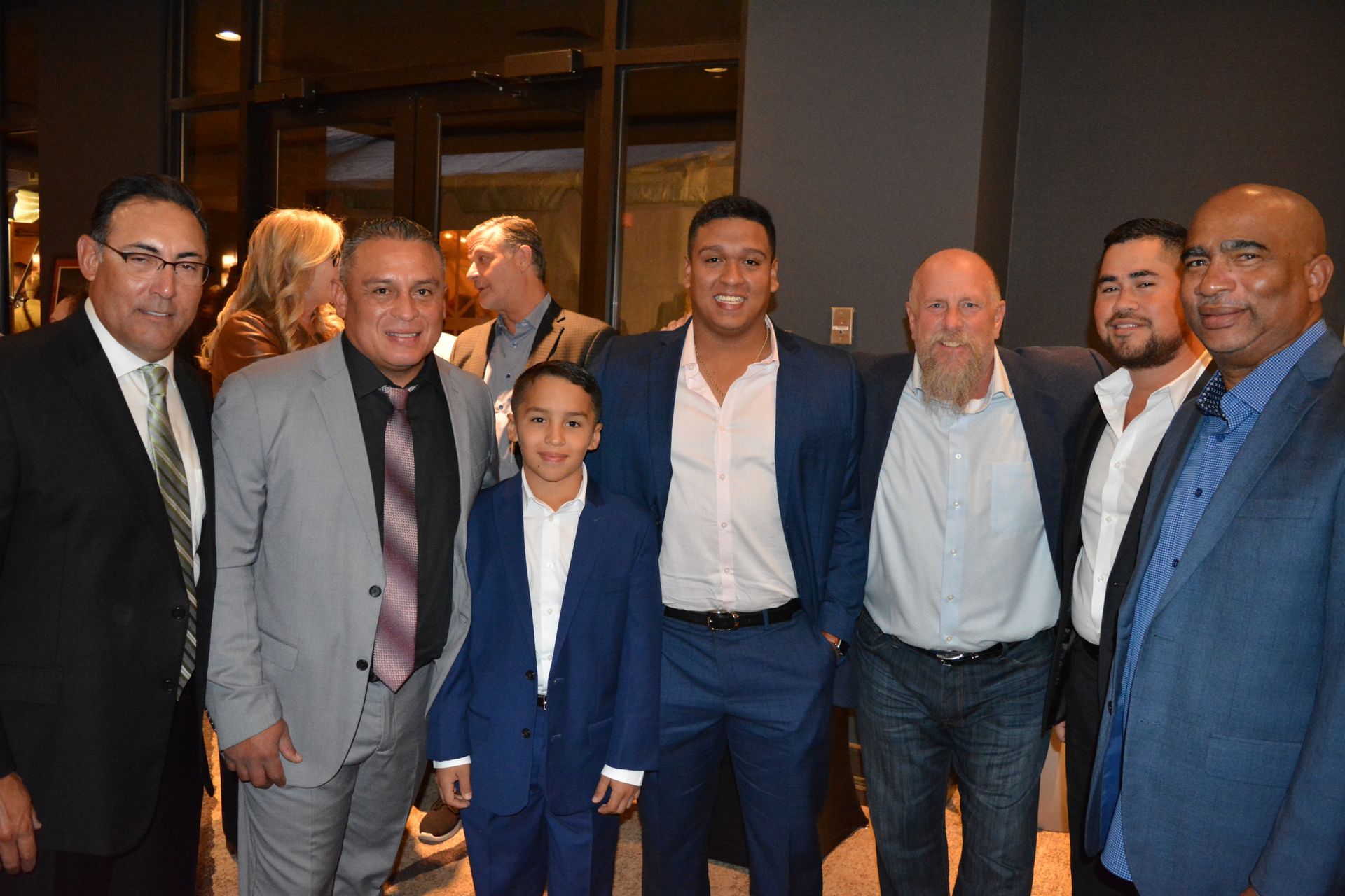 A group of men in suits and ties are posing for a picture.