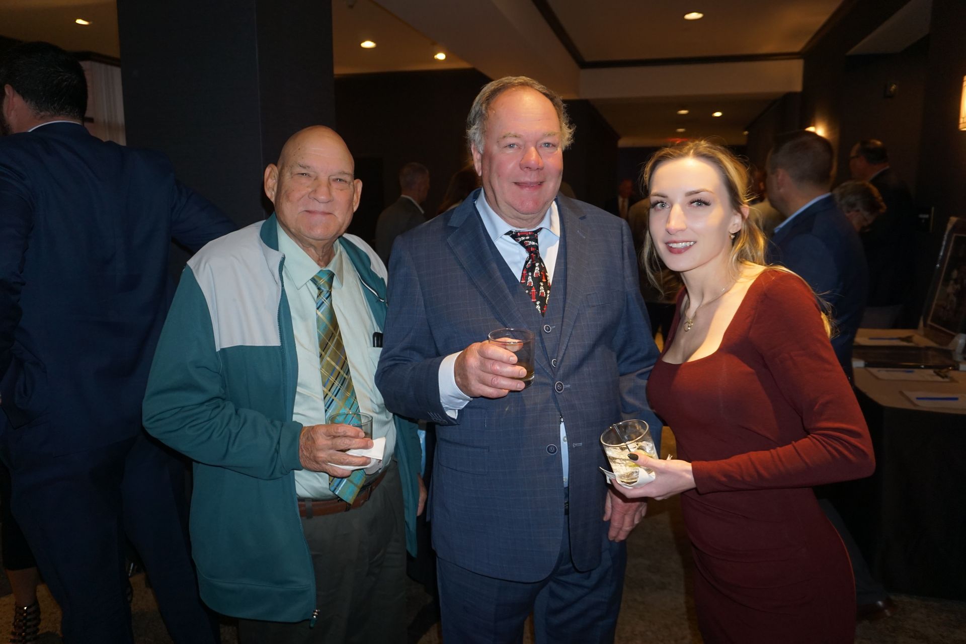 A group of people are standing next to each other in a room.