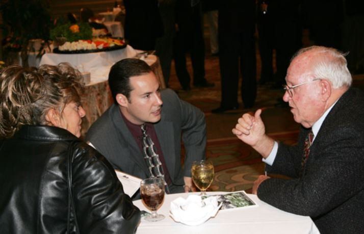 A group of people are sitting at a table having a conversation
