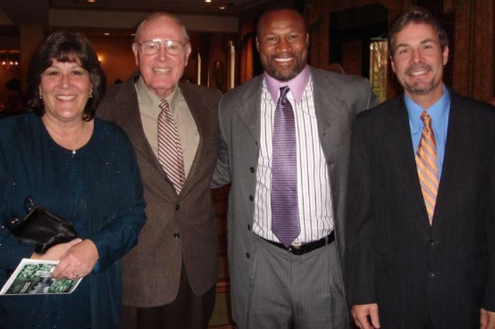 A group of people in suits and ties pose for a picture
