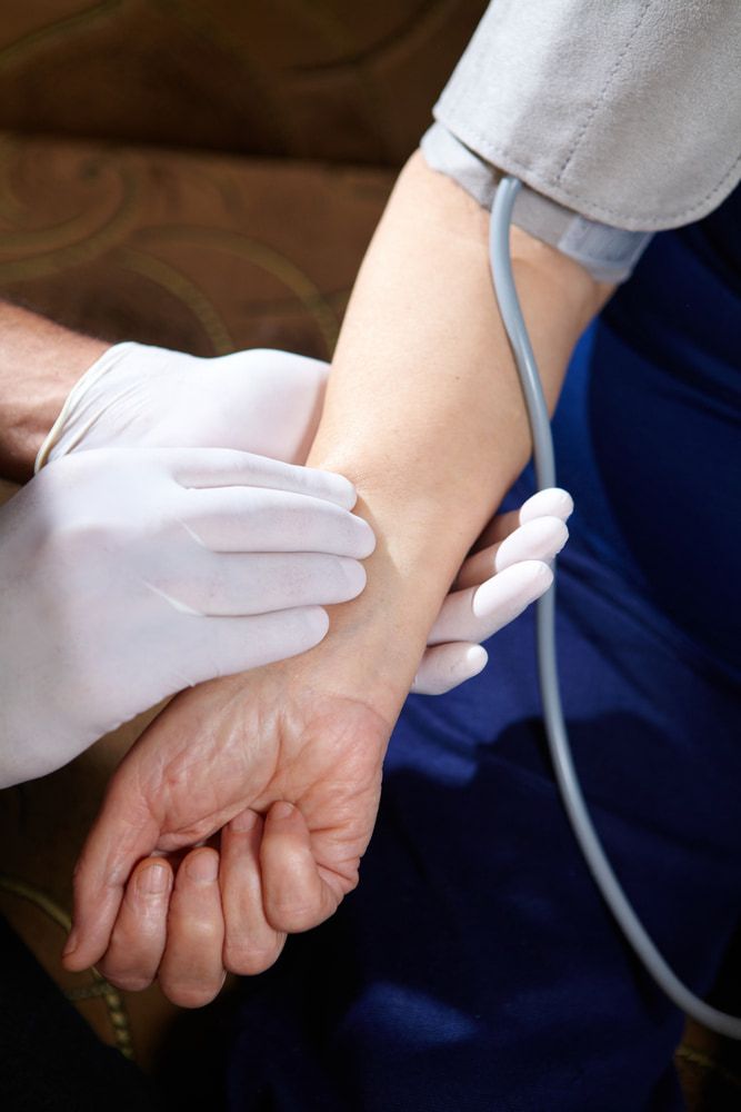 A Doctor Monitoring The Blood Pressure And Pulse Of The Patient — Mall Medical Centre In Alice Springs, NT