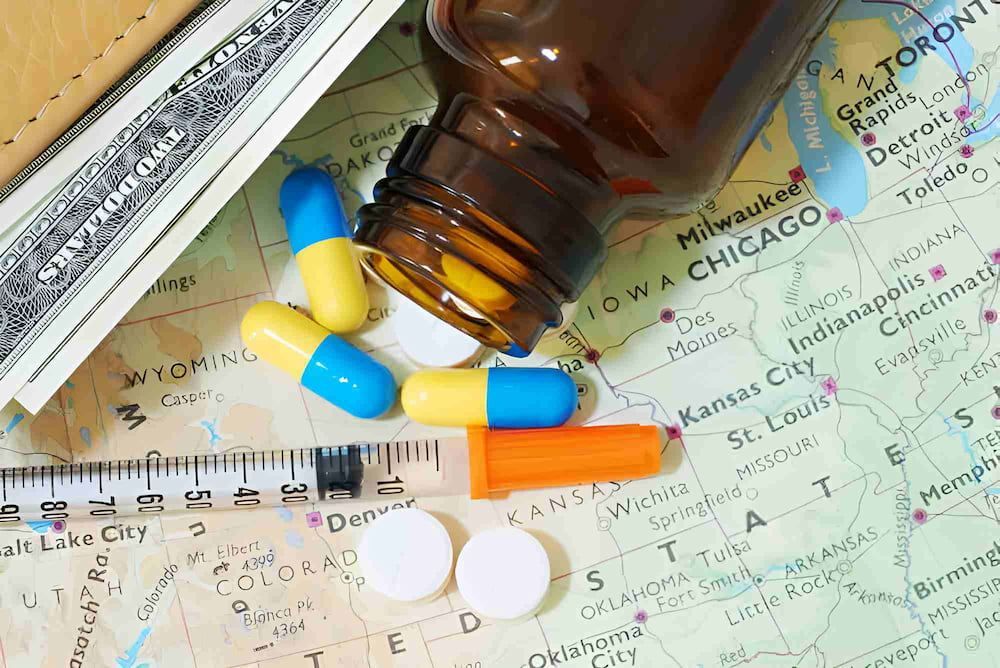A Bottle Of Pills Is Pouring Out Of A Syringe On A Map — Mall Medical Centre In Alice Springs, NT