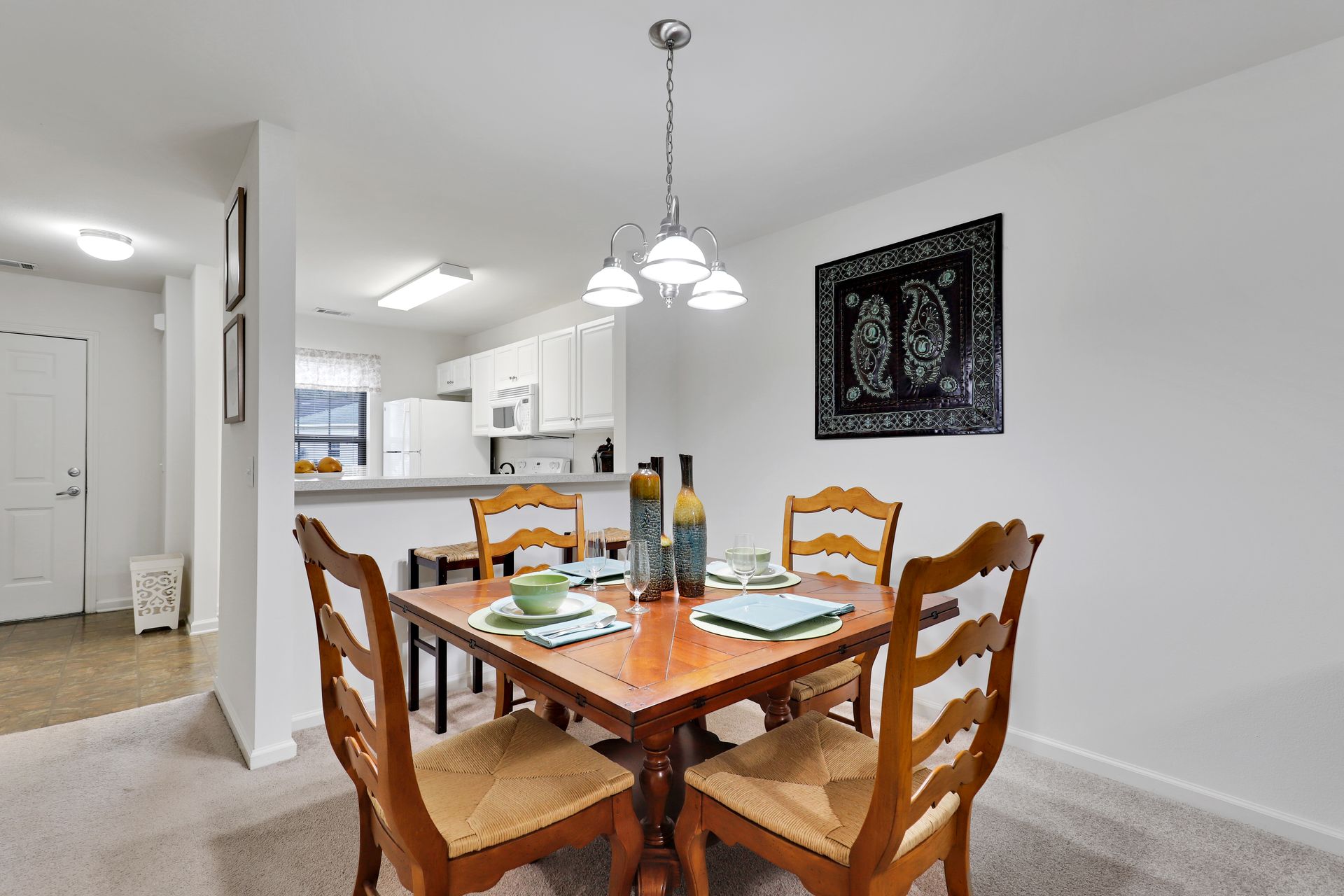 A dining room with a table and chairs and a chandelier.