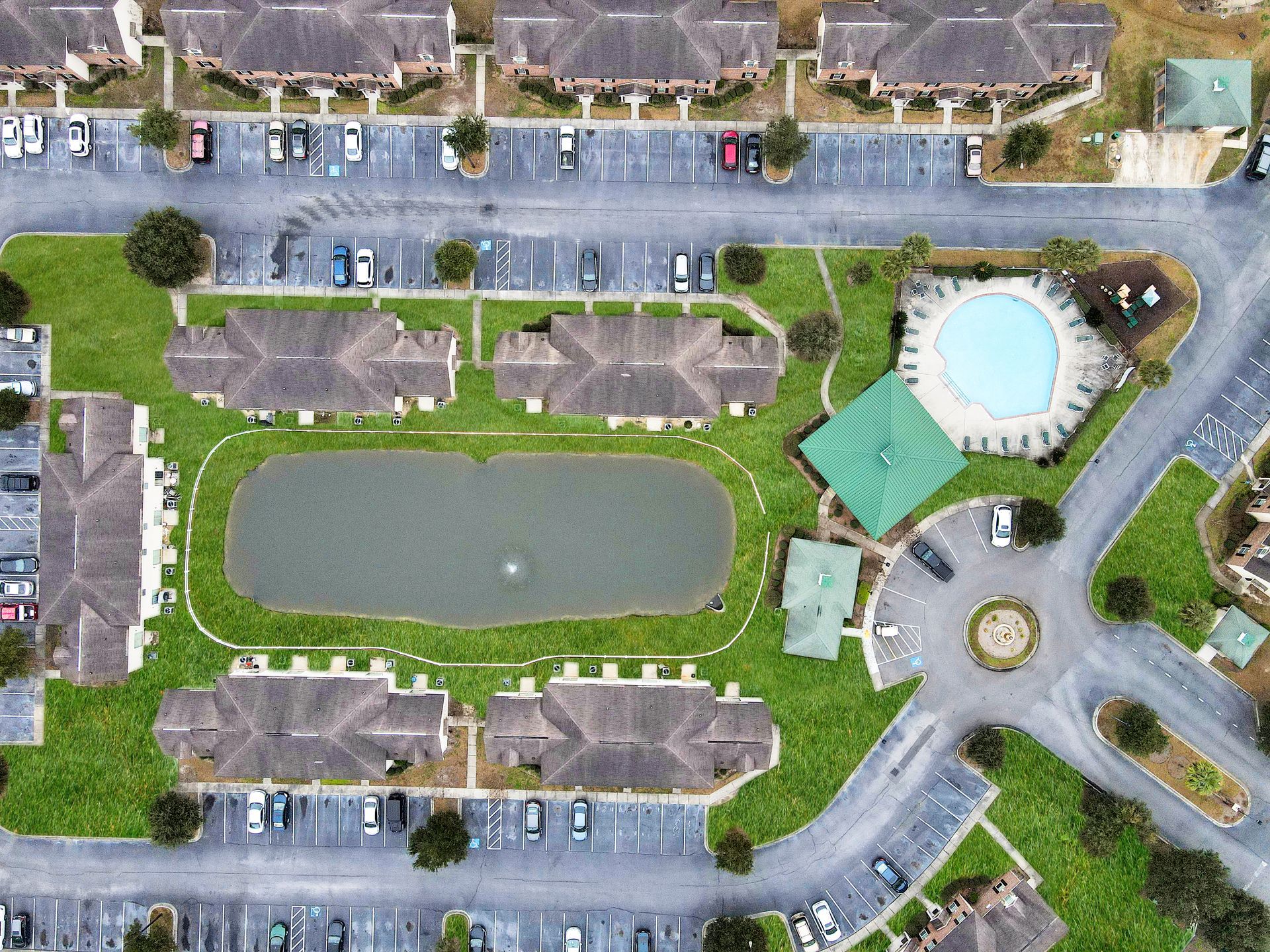 An aerial view of a residential area with a lake in the middle
