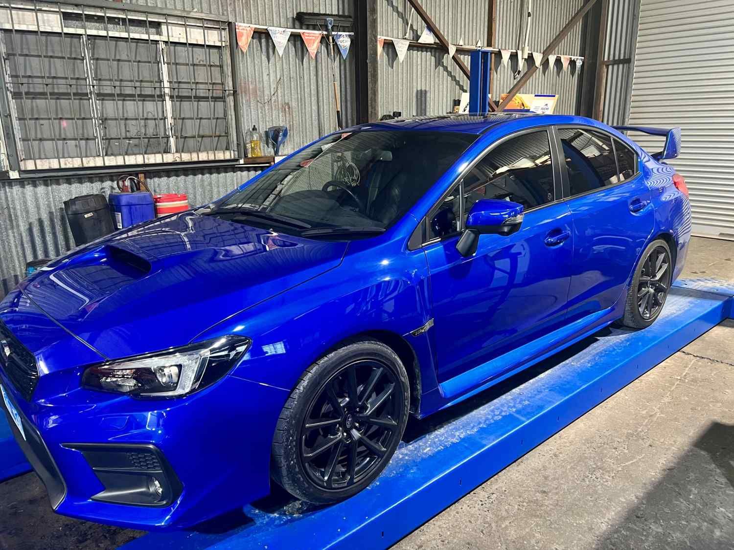 A blue subaru is parked in a garage space — Advanced Automotive Services in Coffs Harbour, NSW