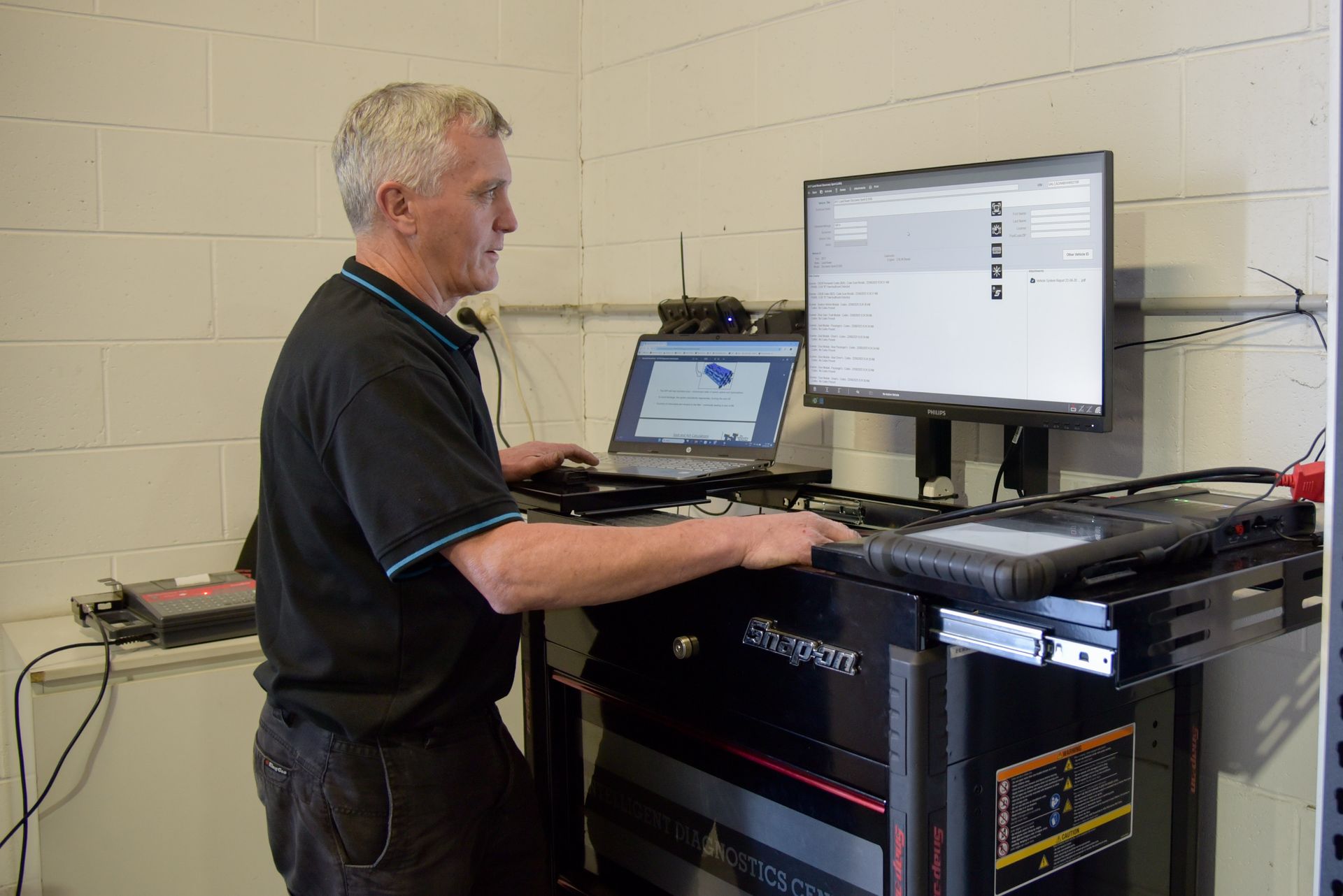A man is standing at a large computer screen while running results on a car — Advanced Automotive Services in Coffs Harbour, NSW