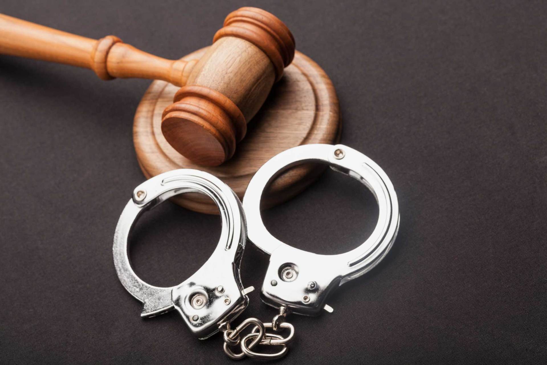 Judge Gavel And Handcuffs On Wooden Desk — Southgate, MI — Colovos Law Firm