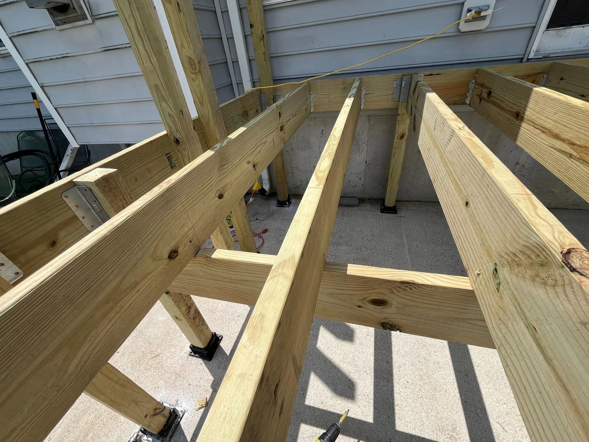 Wooden deck frame under construction outdoors.