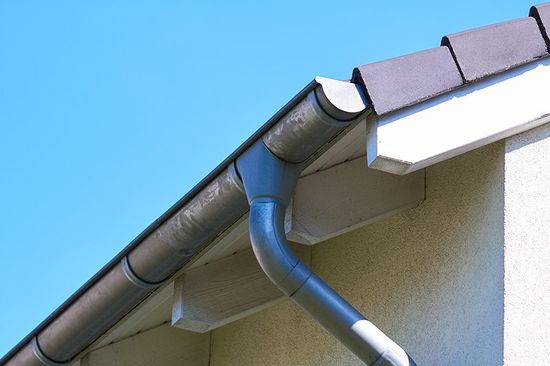 Gutter with downpipe on the roof