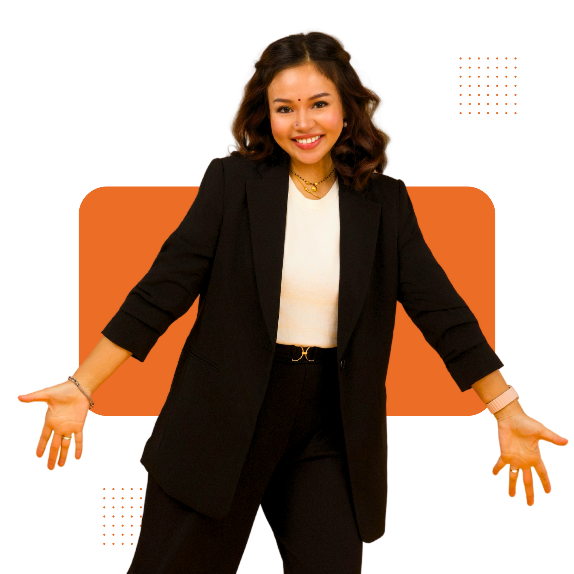 A woman in a black suit is standing with her arms outstretched.